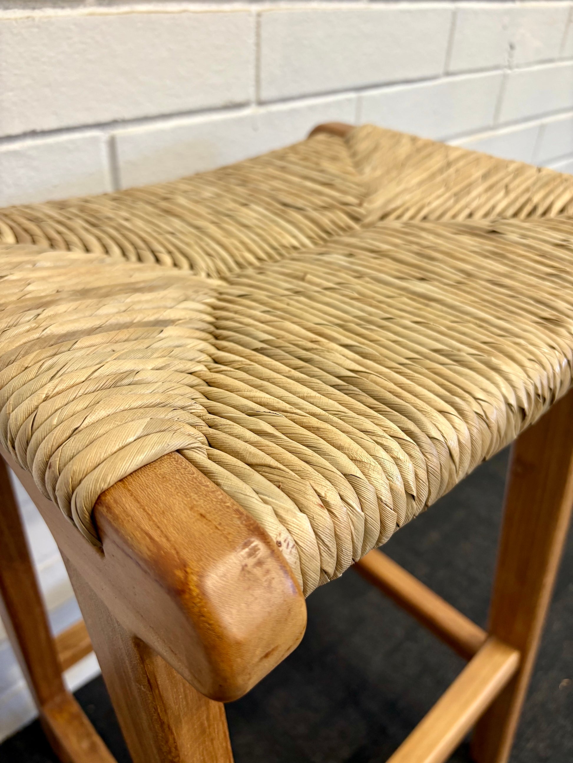 Indus barstool with solid teak wood frame and hand-woven natural pandan seat, featuring a clean, minimalist design suitable for coastal and contemporary interiors. Measures 400 Wide X 350 Depth X 680 Height. Close.