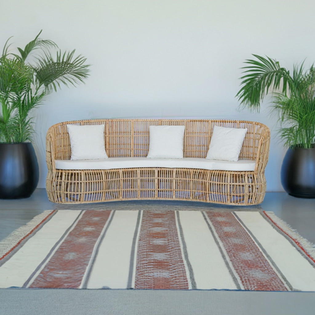 The Kalahari Lounge is an indoor/outdoor lounge. Featuring a rattan frame and UV resistant cushioned seat and back. Colours, natural and white cushions. Measures 2400 length x 900 depth x 900 height with 460 seat height. Styled.