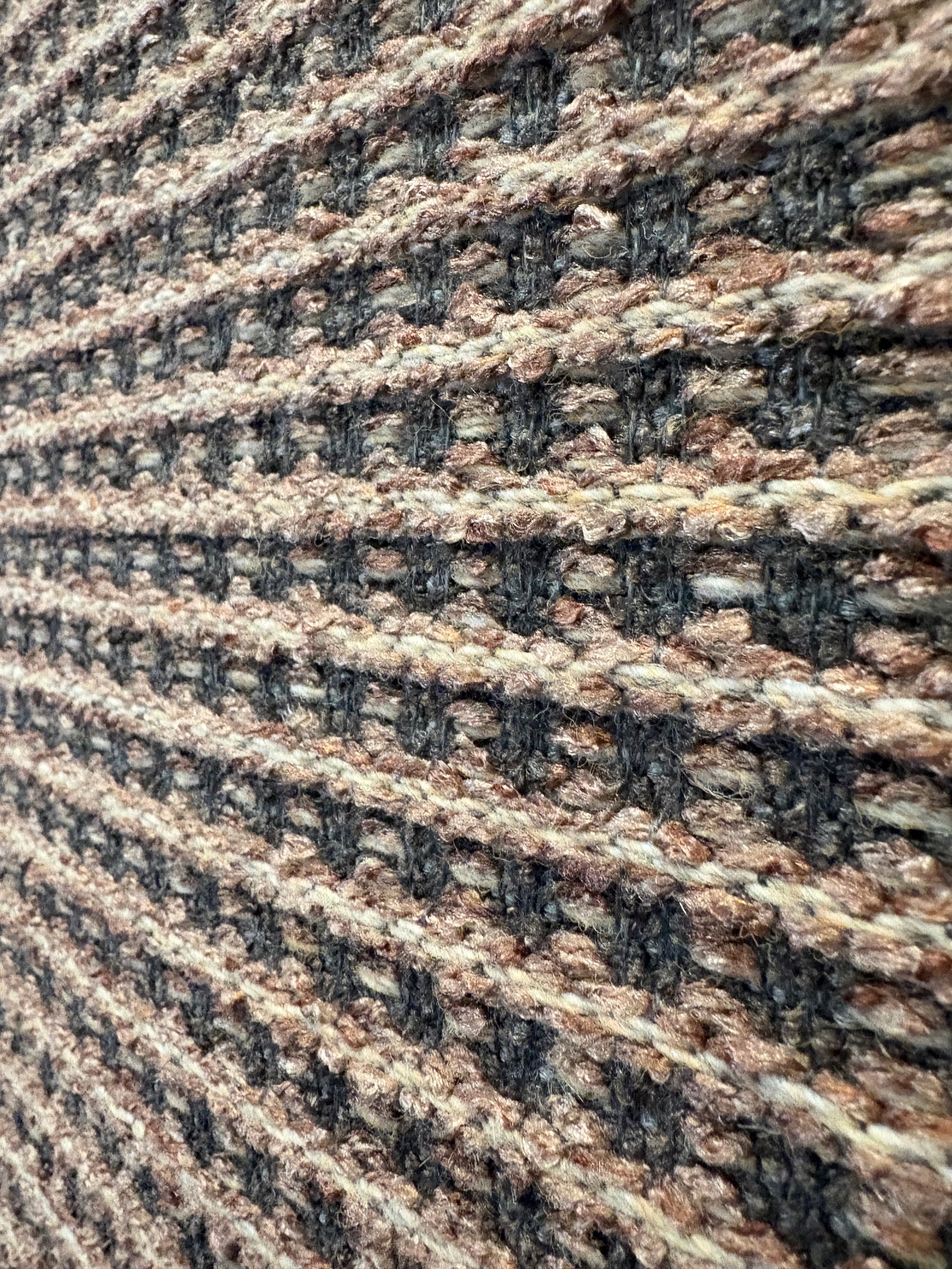 Katana Beige indoor/outdoor rug featuring Beige and light grey/gold tones and a subtle textured pattern, power-loomed from UV-stabilised polypropylene for lasting durability. Colour beige with grey and gold flecks. 3 sizes. Close Angle.
