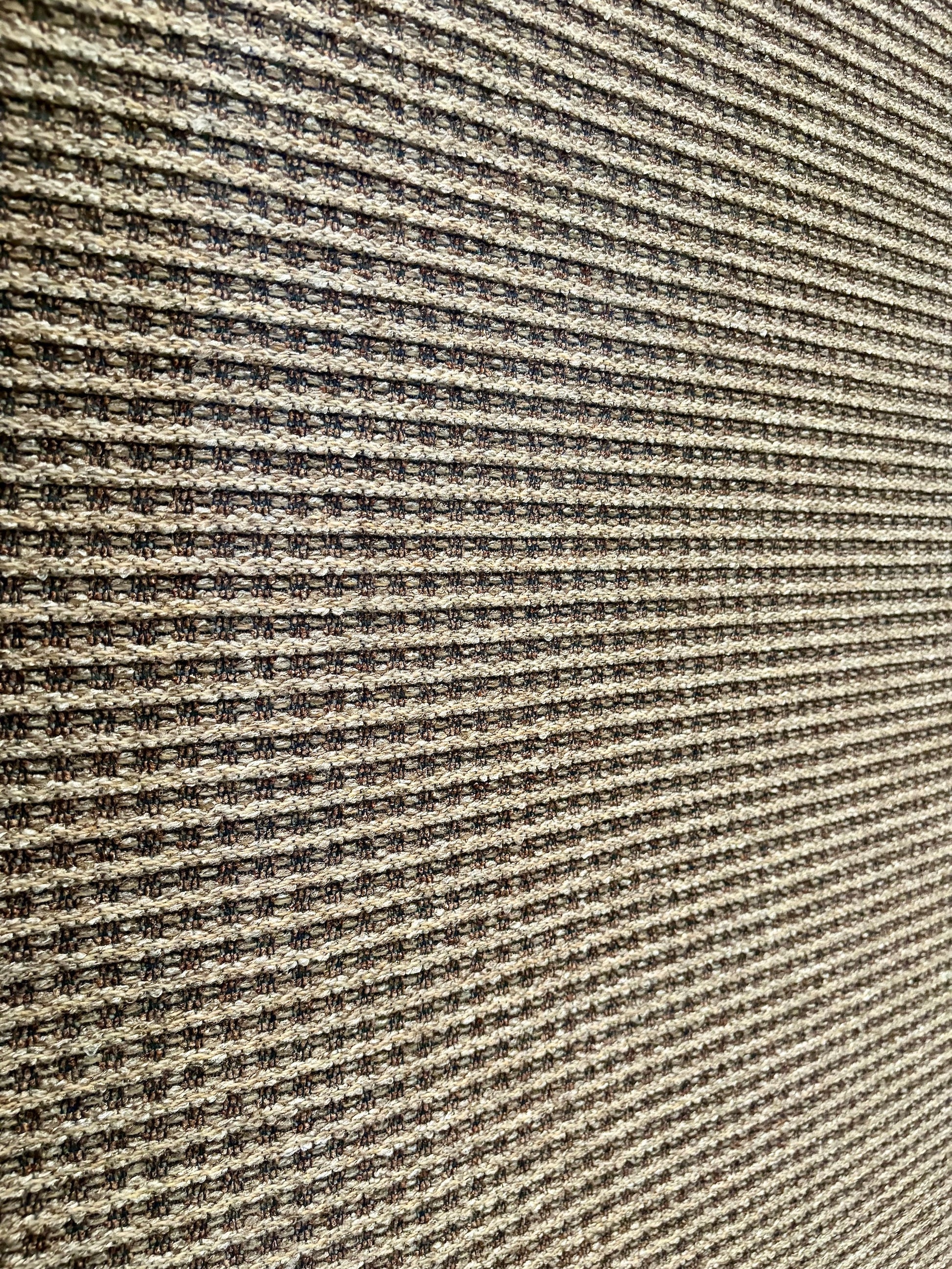 Katana Cream indoor/outdoor rug featuring soft cream and light grey tones and a subtle textured pattern, power-loomed from UV-stabilised polypropylene for lasting durability. Colour creams and light greys. 3 sizes. Angle.