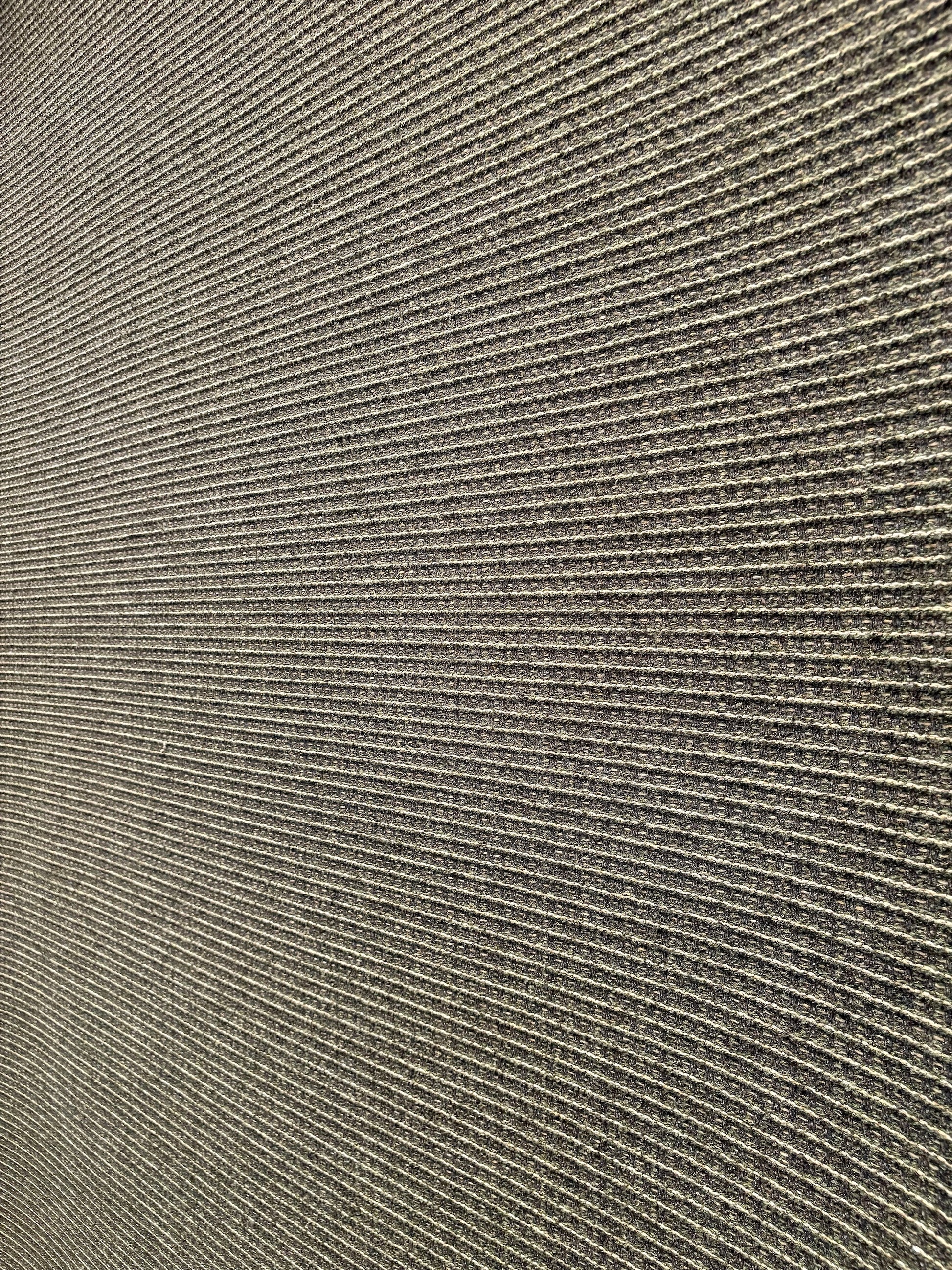 Katana Forest indoor/outdoor rug featuring deep green and light grey tones and a subtle textured pattern, power-loomed from UV-stabilised polypropylene for lasting durability. Colour forest green and light greys. 3 sizes. Angle 1.