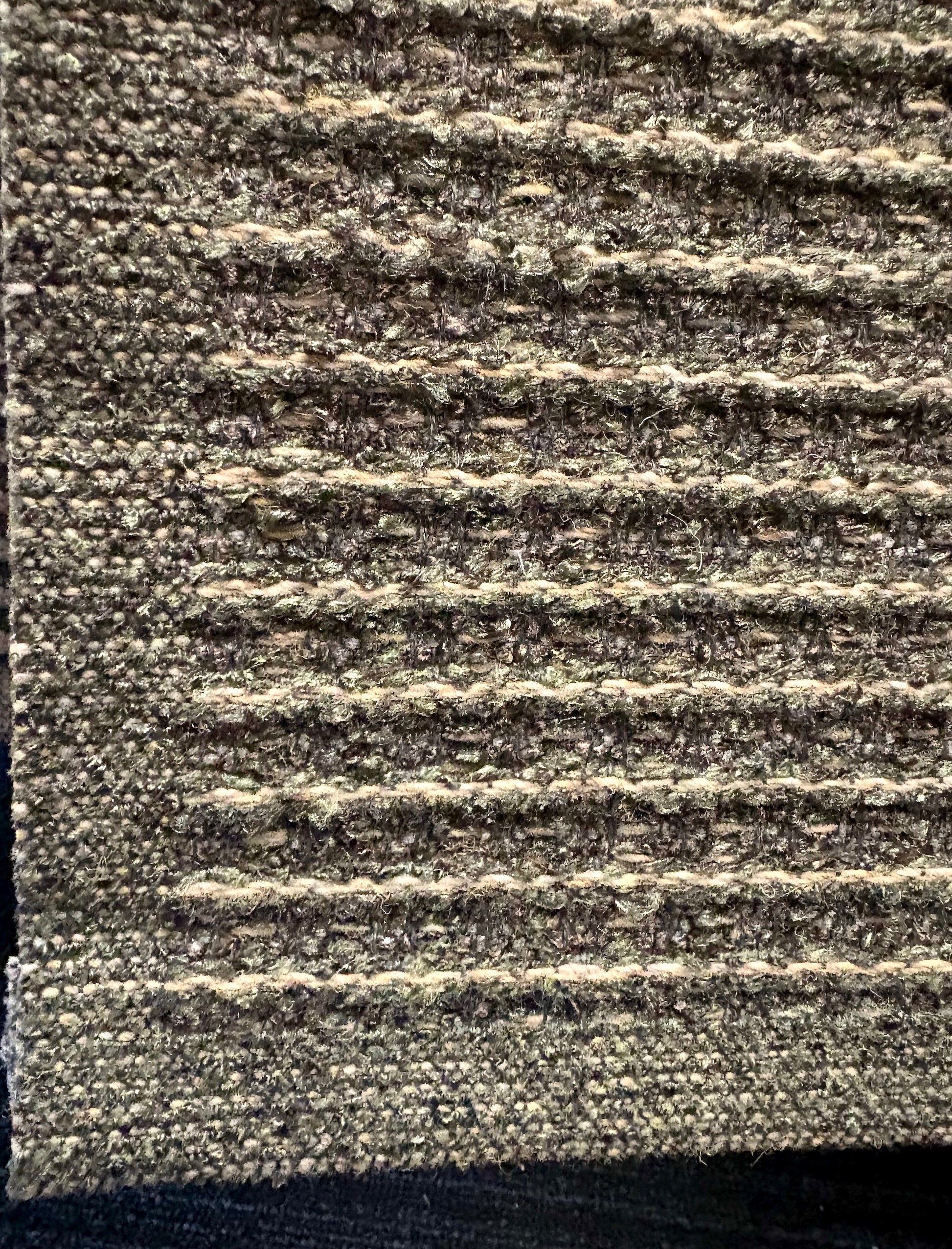 Katana Forest indoor/outdoor rug featuring deep green and light grey tones and a subtle textured pattern, power-loomed from UV-stabilised polypropylene for lasting durability. Colour forest green and light greys. 3 sizes. Corner.