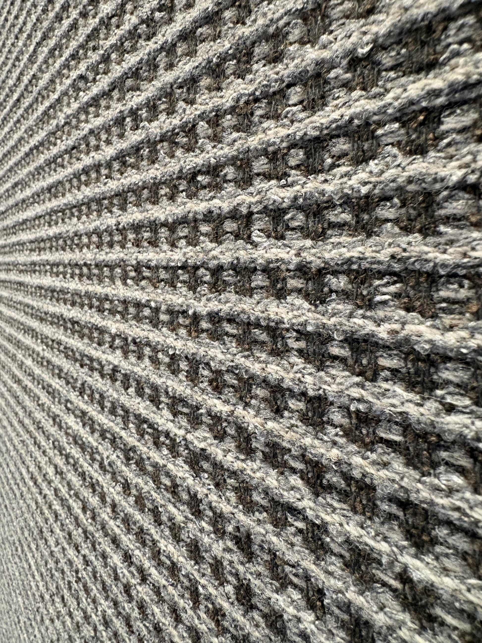Katana Grey indoor/outdoor rug featuring a subtle textured pattern, power-loomed from UV-stabilised polypropylene for lasting durability. Colour grey. 3 sizes. Close Angle.