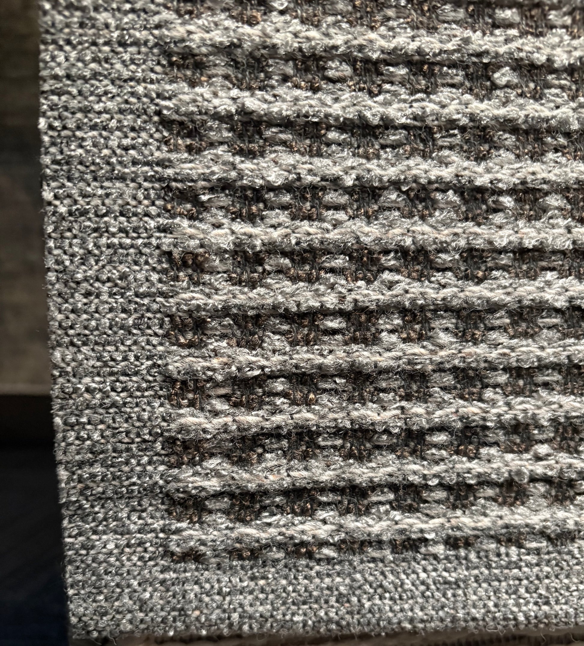 Katana Grey indoor/outdoor rug featuring a subtle textured pattern, power-loomed from UV-stabilised polypropylene for lasting durability. Colour grey. 3 sizes. Corner.