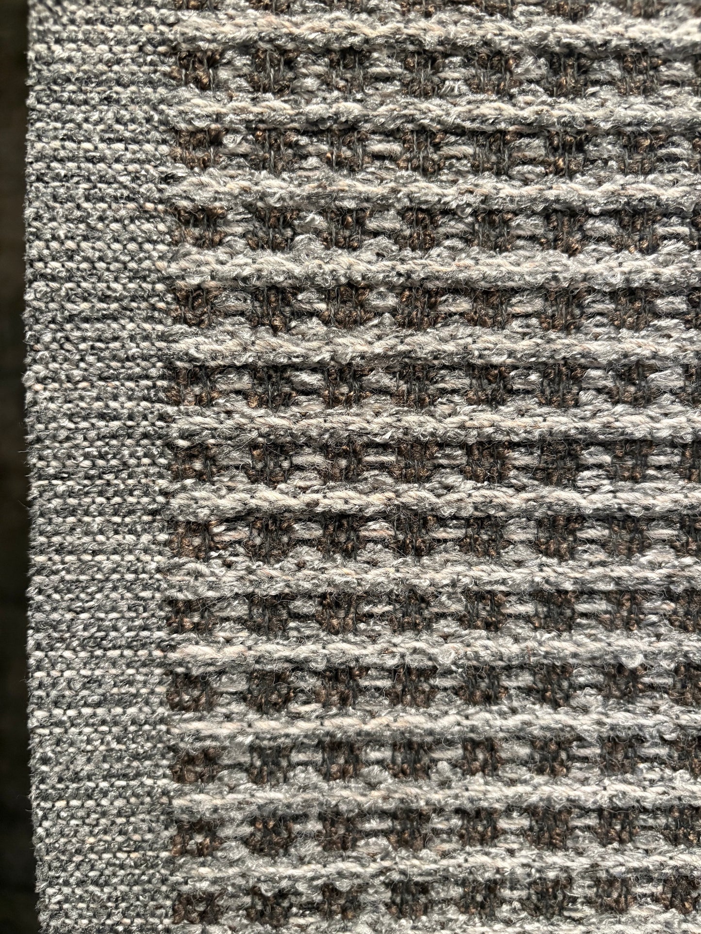 Katana Grey indoor/outdoor rug featuring a subtle textured pattern, power-loomed from UV-stabilised polypropylene for lasting durability. Colour grey. 3 sizes. Side.