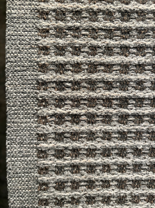 Katana Grey indoor/outdoor rug featuring a subtle textured pattern, power-loomed from UV-stabilised polypropylene for lasting durability. Colour grey. 3 sizes. Side.