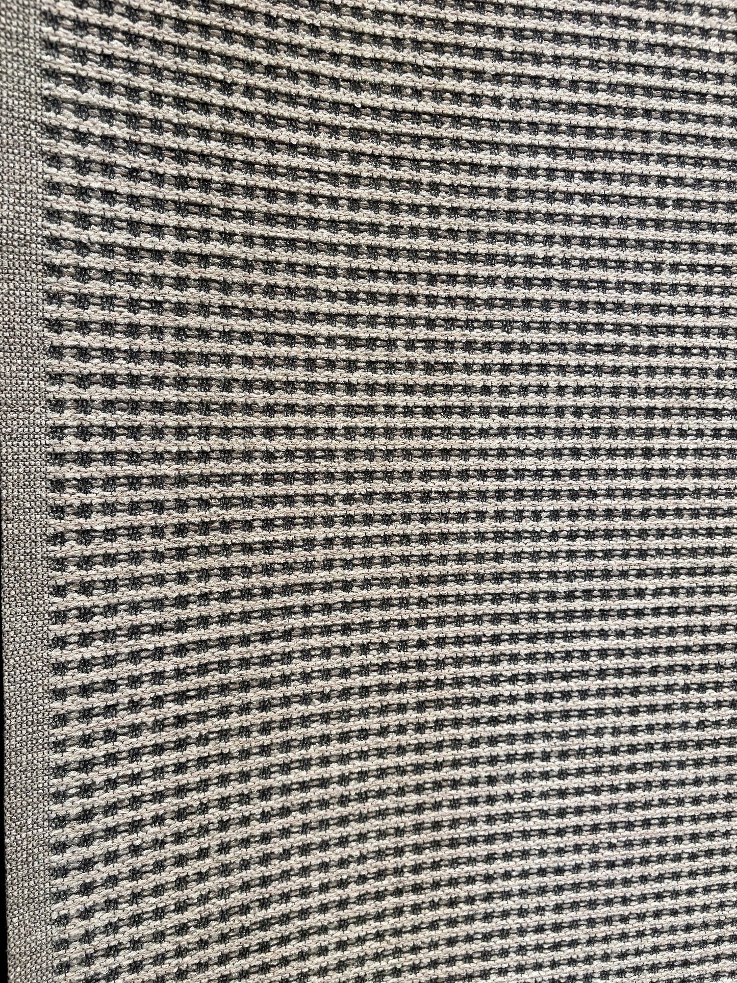 Katana Light Grey indoor/outdoor rug featuring light grey/grey tones and a subtle textured pattern, power-loomed from UV-stabilised polypropylene for lasting durability. Colour light grey. 3 sizes. Angle.
