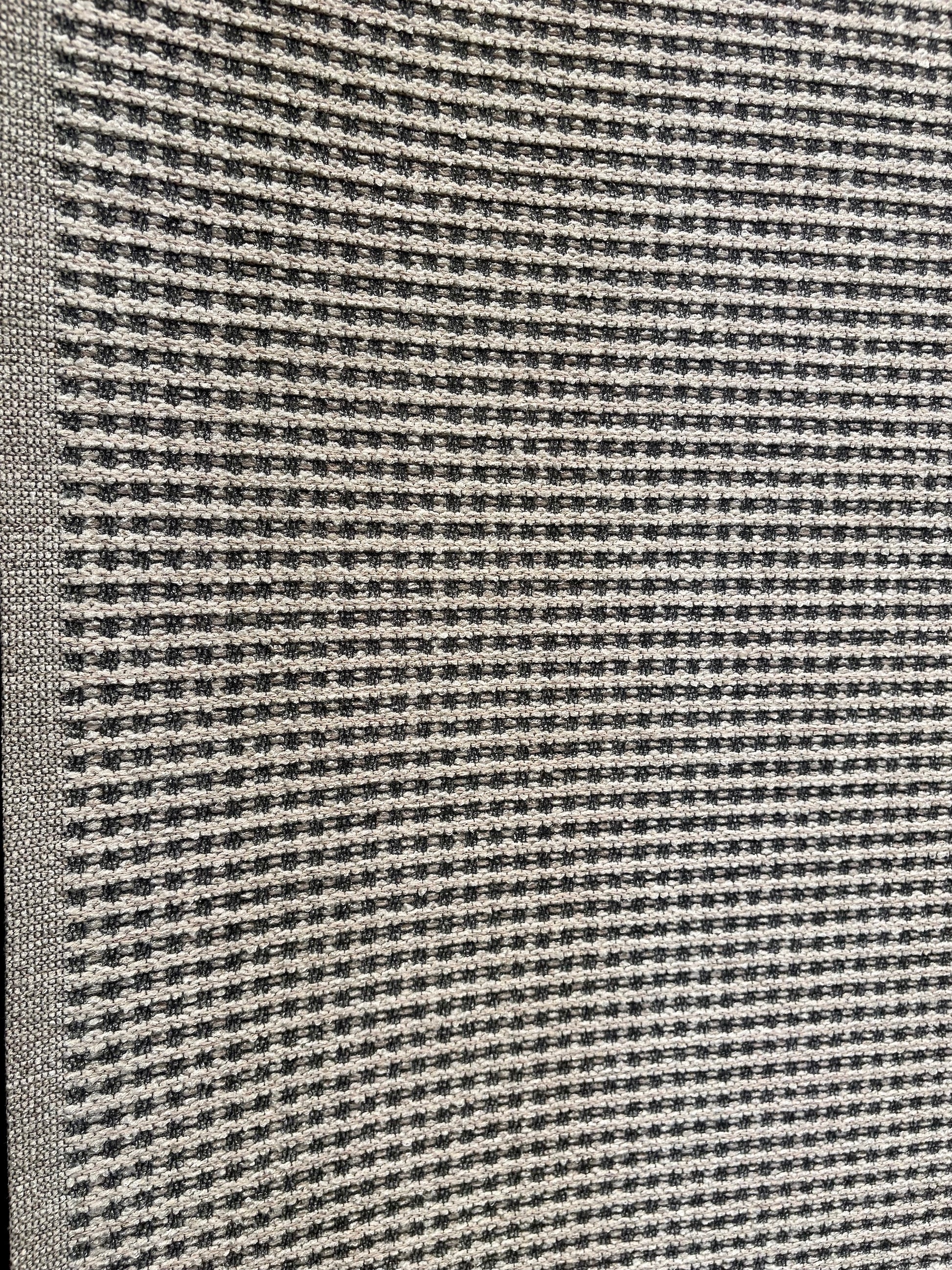 Katana Light Grey indoor/outdoor rug featuring light grey/grey tones and a subtle textured pattern, power-loomed from UV-stabilised polypropylene for lasting durability. Colour light grey. 3 sizes. Angle.