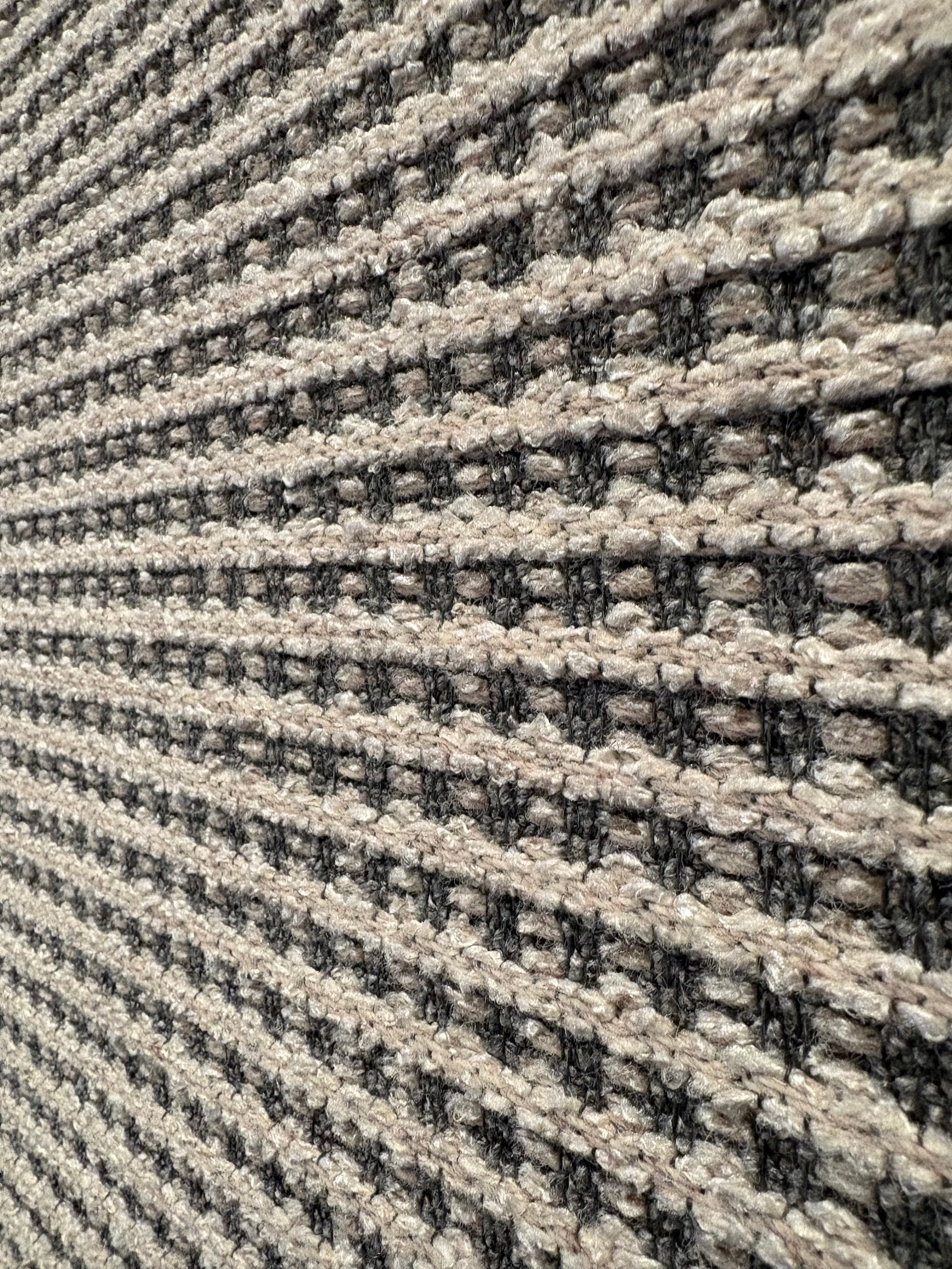 Katana Light Grey indoor/outdoor rug featuring light grey/grey tones and a subtle textured pattern, power-loomed from UV-stabilised polypropylene for lasting durability. Colour light grey. 3 sizes. Close Angle.