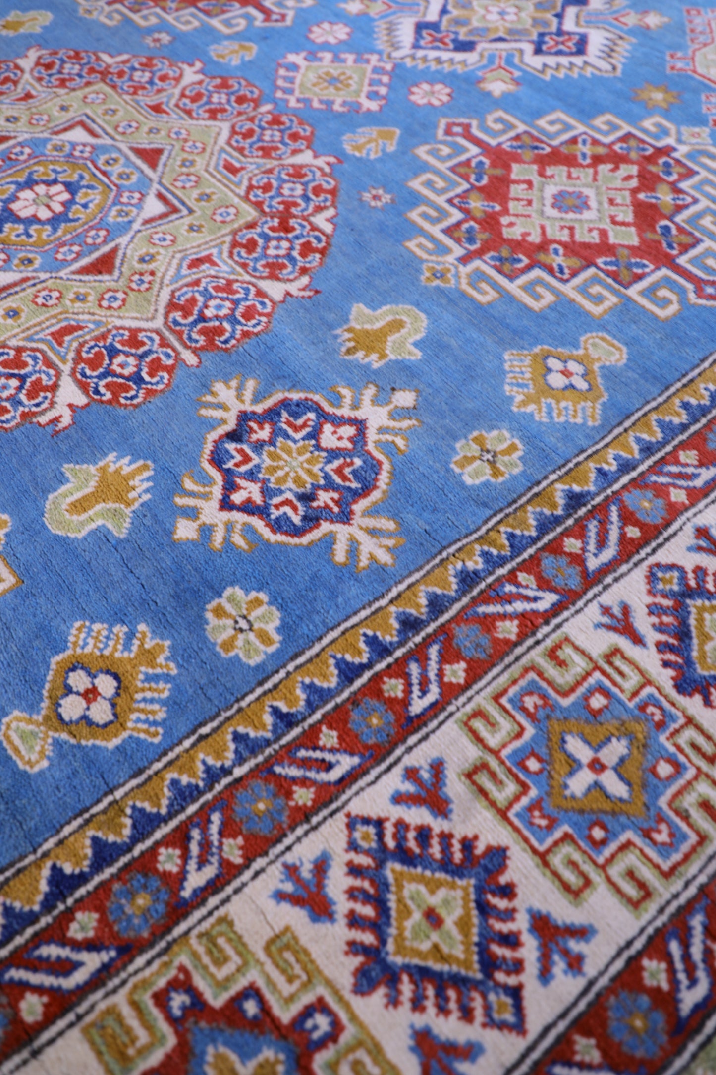 The Hand Knotted Kazak Rug 203 X 298. This wool rug combines superior durability with a traditional flair. 100% hand knotted wool. Measures 203 wide X 298 Length. Ochoco Hand Knotted Rugs Perth. Side.