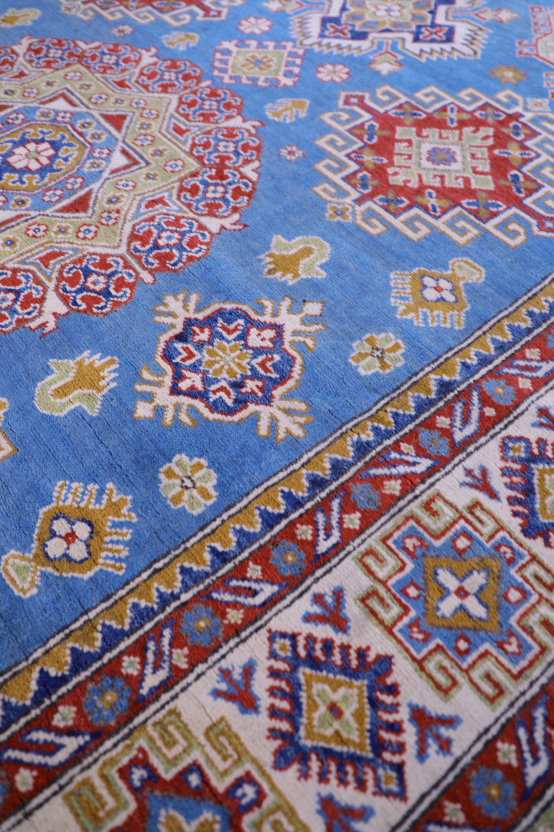 The Hand Knotted Kazak Rug 203 X 298. This wool rug combines superior durability with a traditional flair. 100% hand knotted wool. Measures 203 wide X 298 Length. Ochoco Hand Knotted Rugs Perth. Side.