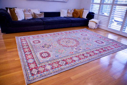 The Hand Knotted Kazak - 203 X 303. This wool rug combines superior durability with a traditional flair. 100% hand knotted wool. Measures 203 wide x 303 length. Life.