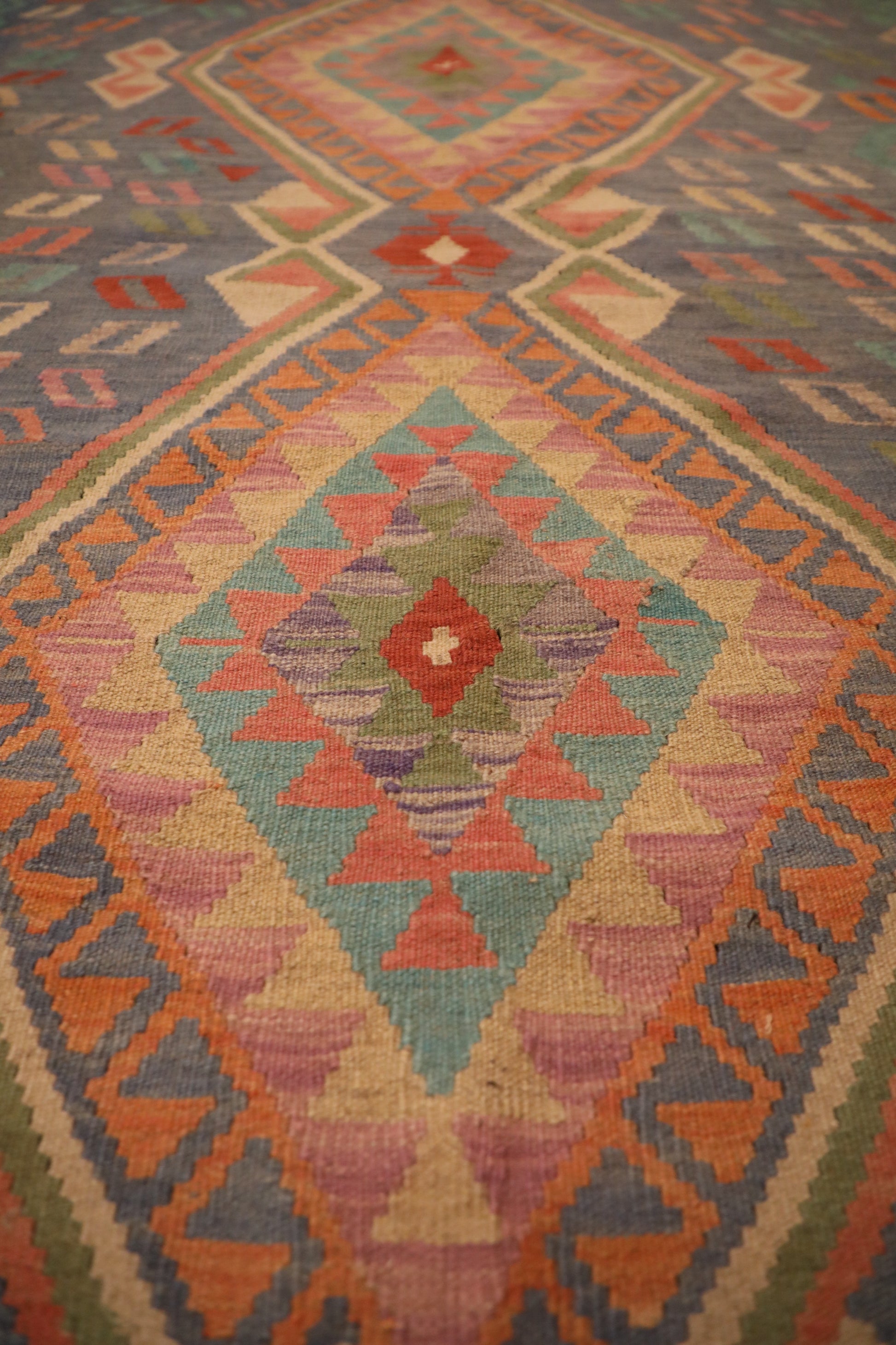 The Afghan Hand Woven Khyber Kilim - 130 X 193. Crafted using traditional vegetable dyed wool, and featuring traditional geometric designs. Colours, blues, lavenders, beiges, creams, oranges. Size 130 X 193. Close.