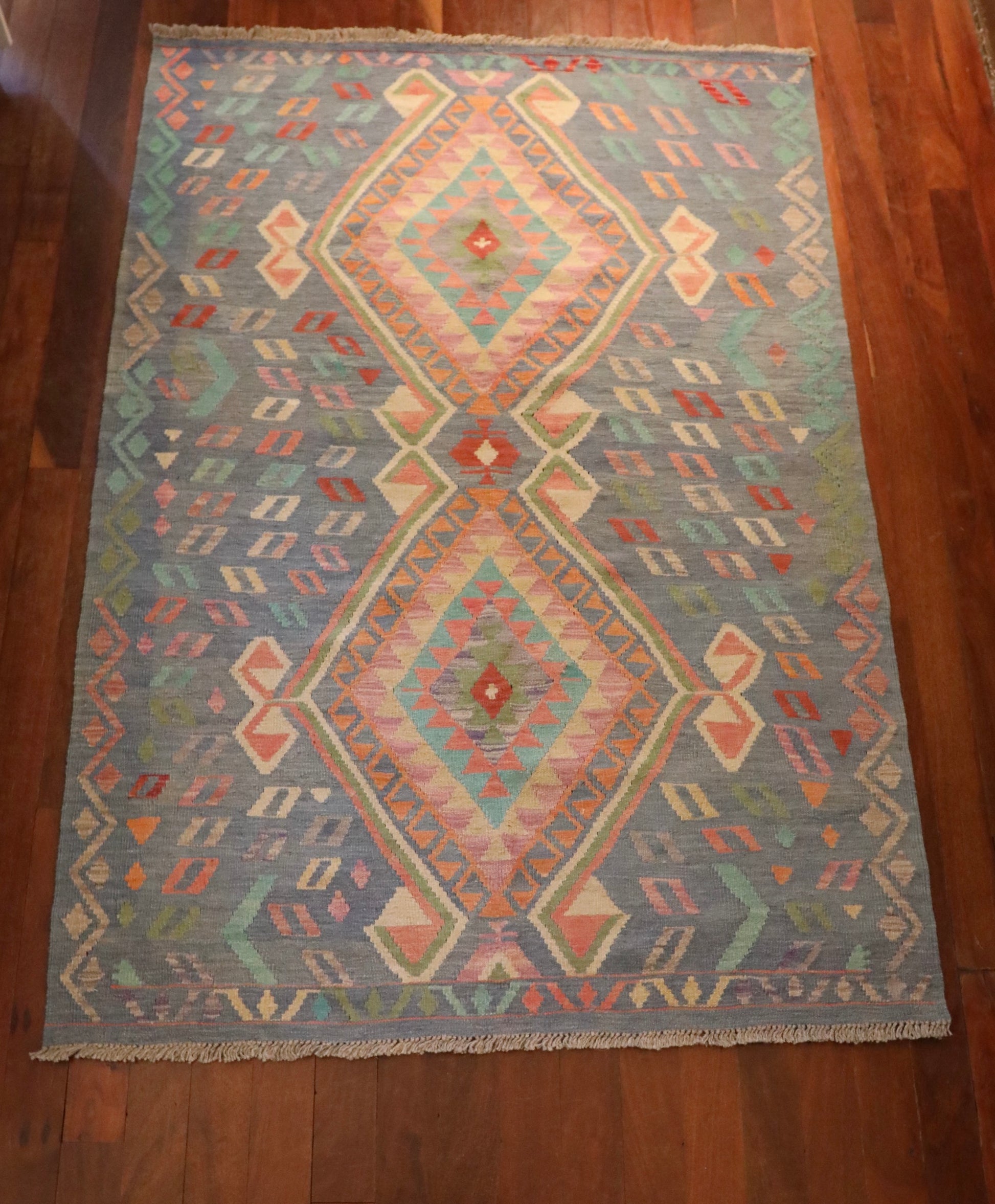 The Afghan Hand Woven Khyber Kilim - 130 X 193. Crafted using traditional vegetable dyed wool, and featuring traditional geometric designs. Colours, blues, lavenders, beiges, creams, oranges. Size 130 X 193. Top.