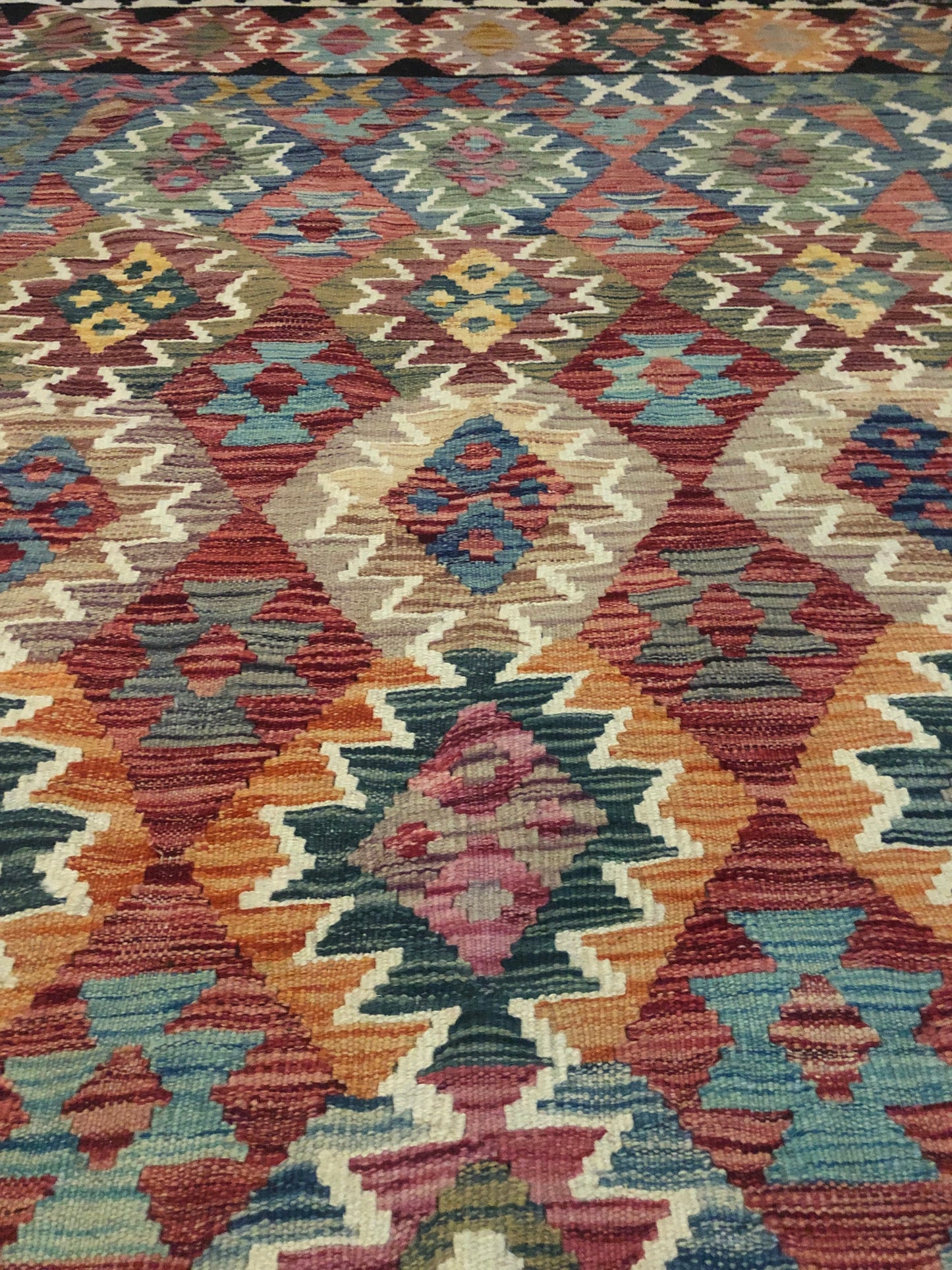 The Afghan Hand Woven Khyber Kilim - 202 X 290.  Crafted using traditional vegetable dyed wool, and featuring traditional geometric designs. Colours, blacks, blues, creams, reds, oranges and yellows. Size 202 X 290. Close.