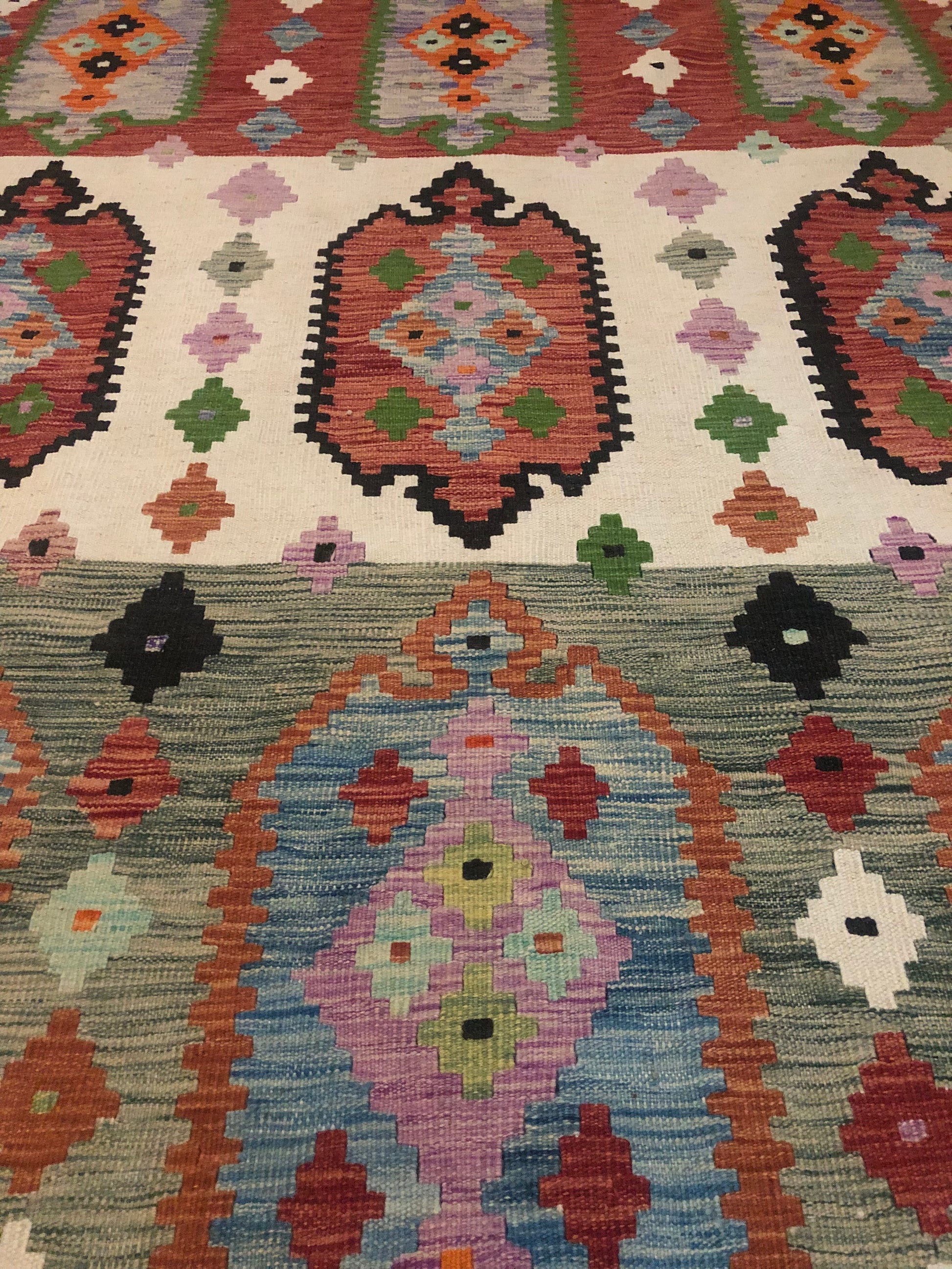 The Afghan Hand Woven Khyber Kilim - 208 X 300.  Crafted using traditional vegetable dyed wool, and featuring traditional geometric designs. Colours, blacks, blues, creams, reds, oranges and yellows. Size 208 X 300. Close.