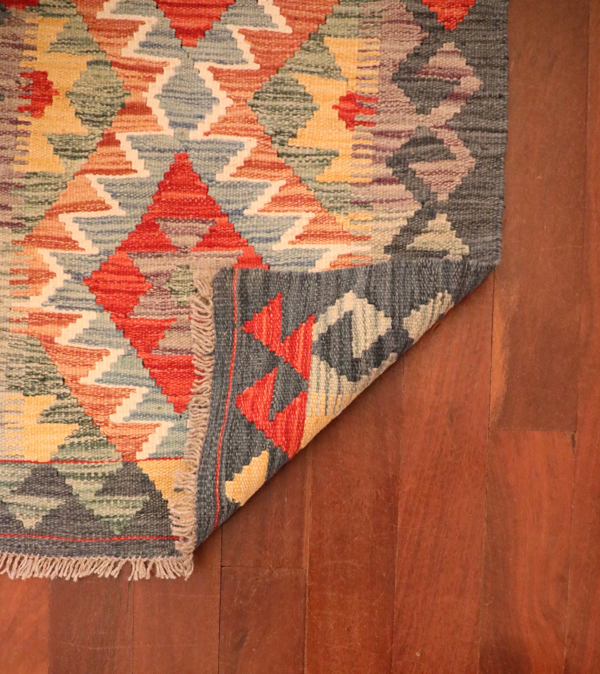 The Afghan Hand Woven Khyber Kilim - 57 X 91. Crafted using traditional vegetable dyed wool, and featuring traditional geometric designs. Colours, dark greys, beiges, blues, creams, light greens, light blues and yellows. Size 57 X 91. Fold.