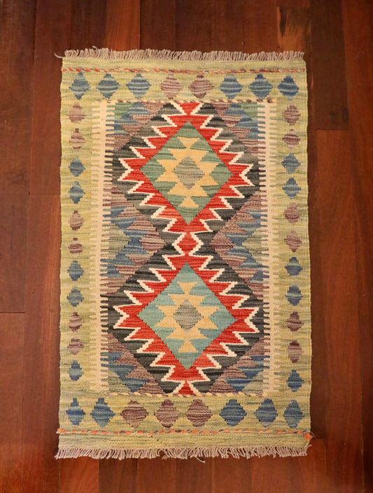  The Afghan Hand Woven Khyber Kilim - 59 X 90. Crafted using traditional vegetable dyed wool, and featuring traditional geometric designs. Colours, beiges, blues, creams, light greens, light blues and yellows. Size 59 X 90. Top.