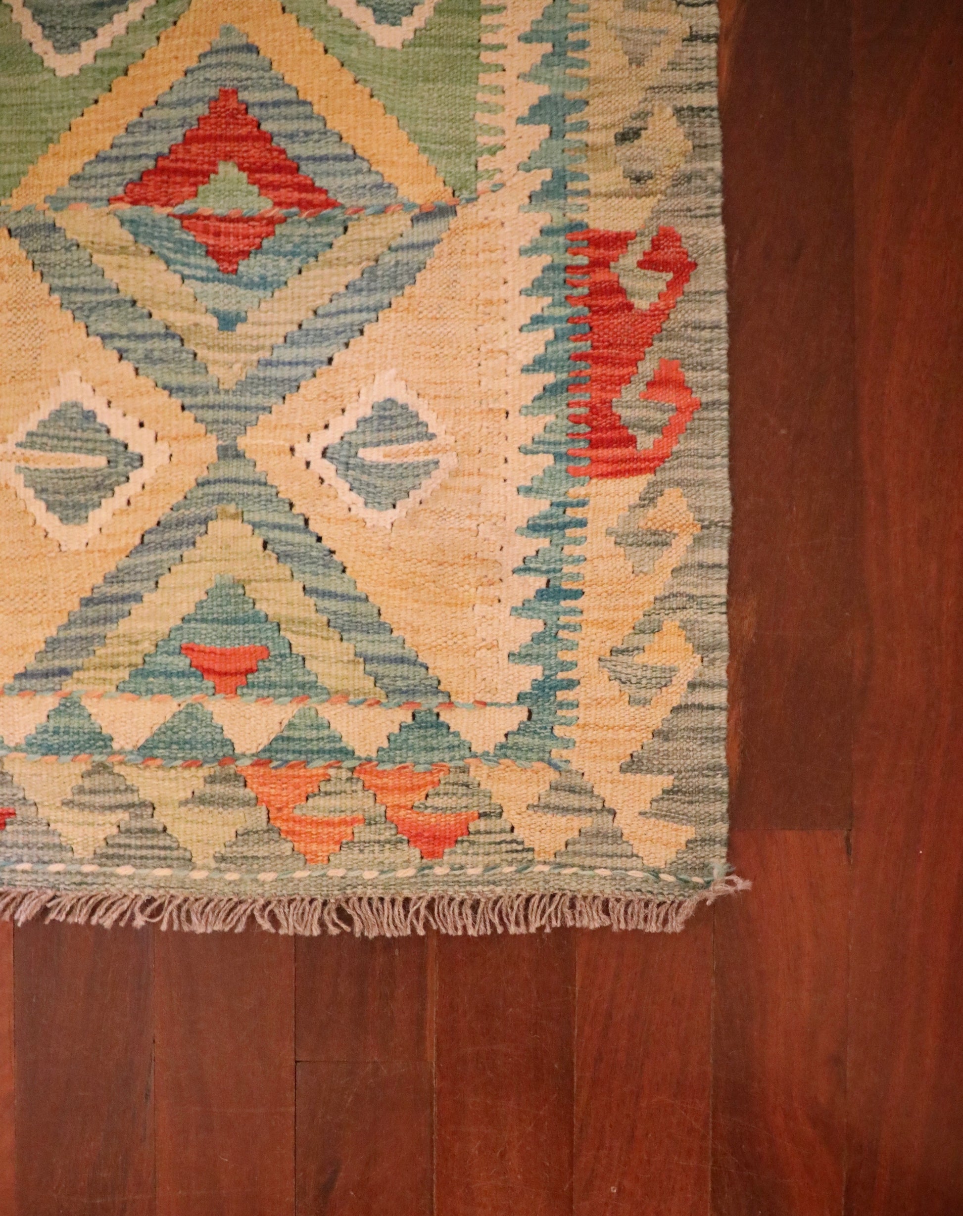  The Afghan Hand Woven Khyber Kilim - 60 X 84. Crafted using traditional vegetable dyed wool, and featuring traditional geometric designs. Colours, Dark oranges, creams, light greens, light blues yellows. Size 60 X 84. Corner.