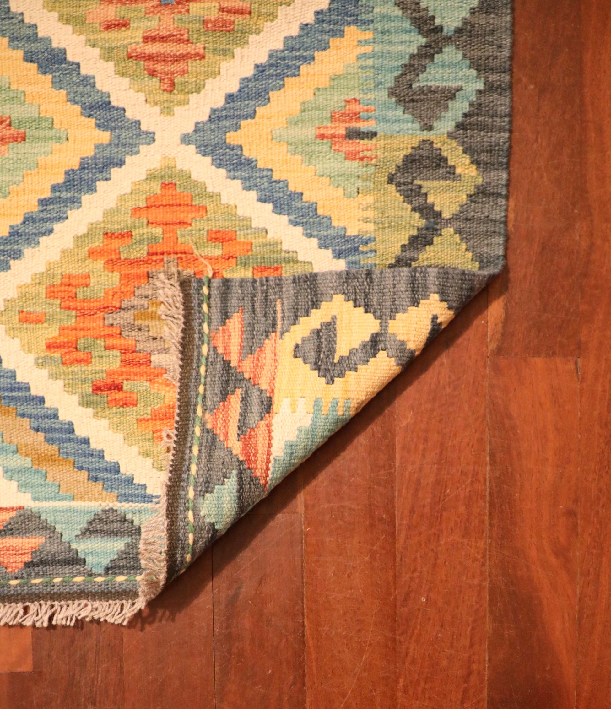 The Afghan Hand Woven Khyber Kilim - 60 X 87. Crafted using traditional vegetable dyed wool, and featuring traditional geometric designs. Colours, dark greys, beiges, blues, creams, light greens, light blues and yellows. Size 60 X 87. Fold.