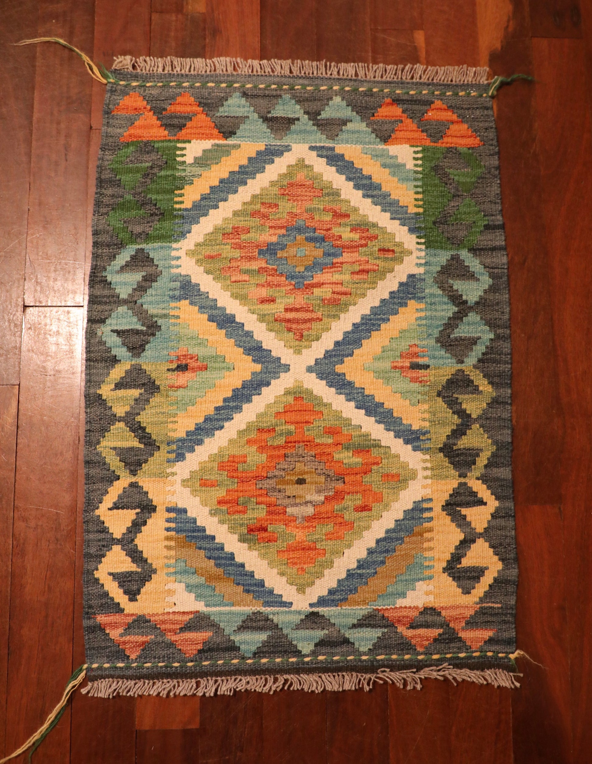 The Afghan Hand Woven Khyber Kilim - 60 X 87. Crafted using traditional vegetable dyed wool, and featuring traditional geometric designs. Colours, dark greys, beiges, blues, creams, light greens, light blues and yellows. Size 60 X 87. Top.
