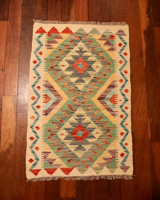 The Afghan Hand Woven Khyber Kilim 60 X 90. Crafted using traditional vegetable dyed wool, and featuring traditional geometric designs. Colours, beige, greens, light blues, yellows and reds. Size 60 X 90. Top.
