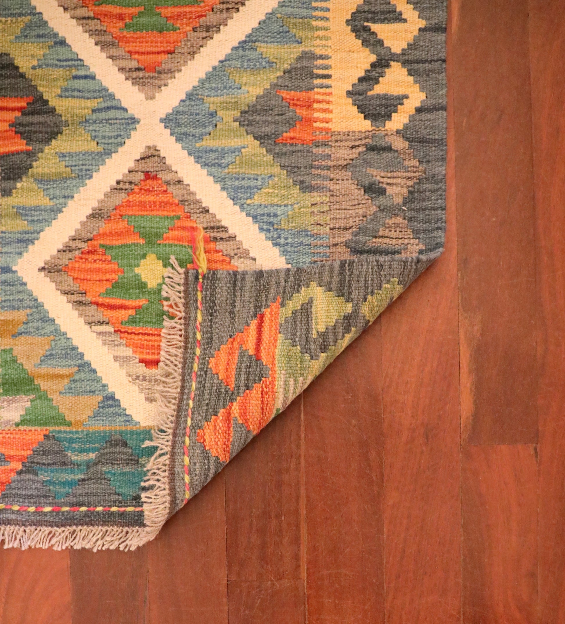The Afghan Hand Woven Khyber Kilim - 61 X 86. Crafted using traditional vegetable dyed wool, and featuring traditional geometric designs. Colours, dark greys, beiges, blues, creams, light greens, light blues and yellows. Size 61 X 86. Fold.