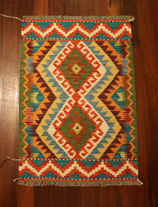 The Afghan Hand Woven Khyber Kilim - 62 X 87. Crafted using traditional vegetable dyed wool, and featuring traditional geometric designs. Colours, reds, beiges, creams, oranges, light greens, light blues and yellows. Size 62 X 87. Top.