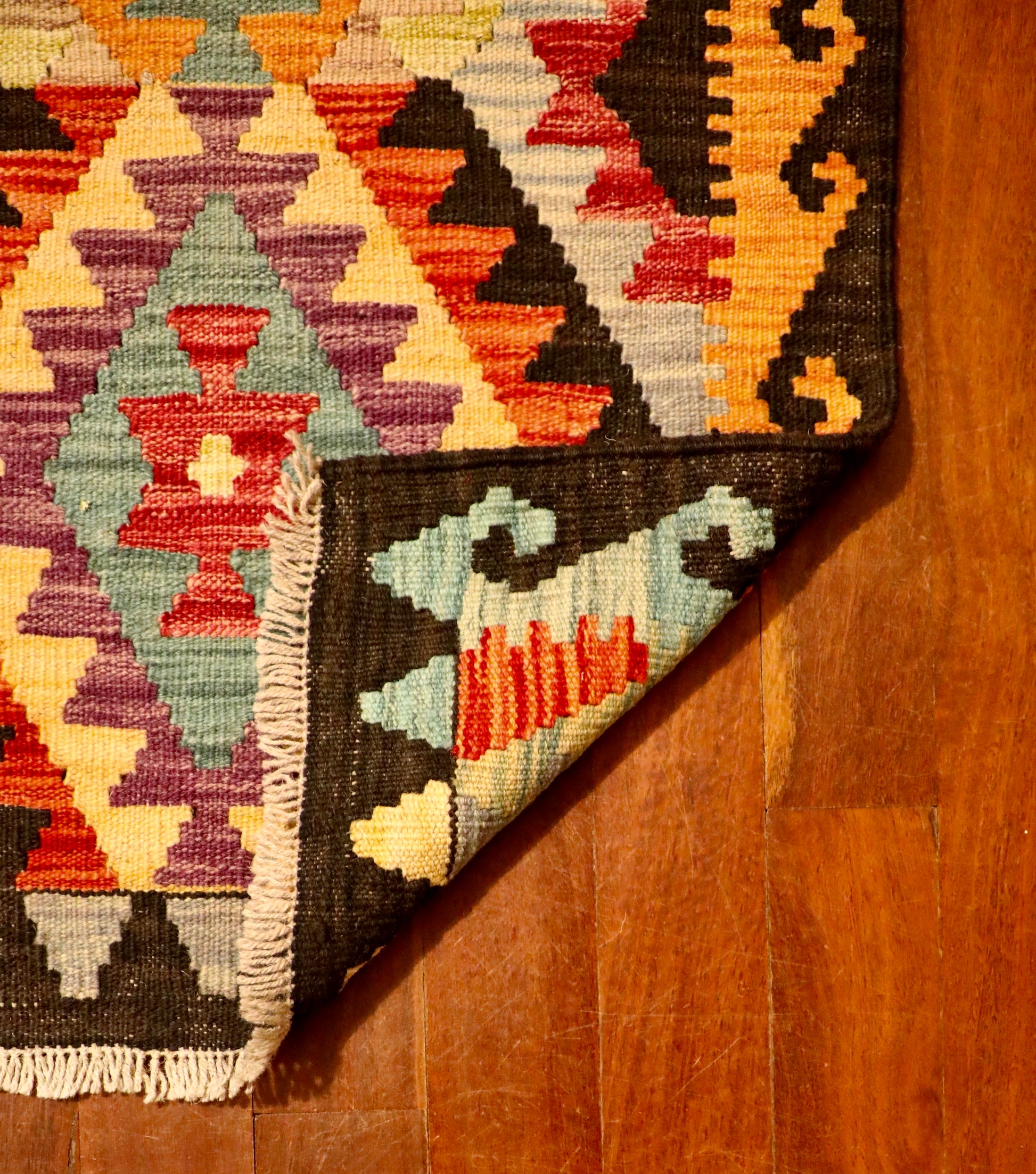 The Afghan Hand Woven Khyber Kilim - 65 X 87. Crafted using traditional vegetable dyed wool, and featuring traditional geometric designs. Colours, navy blue, reds, beiges, creams, oranges, light greens, light blues and yellows. Size 65 X 87. Fold.