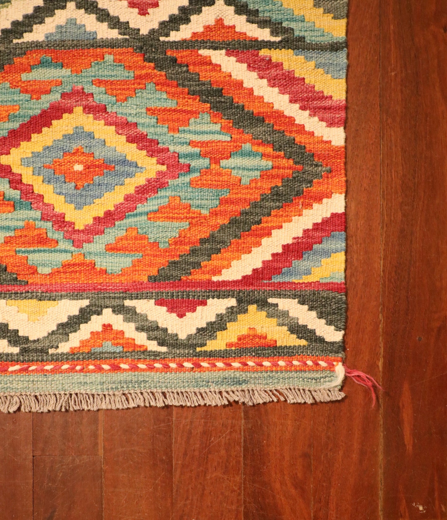 The Afghan Hand Woven Khyber Kilim - 65 X 90. Crafted using traditional vegetable dyed wool, and featuring traditional geometric designs. Colours, reds, beiges, creams, light greens, light blues and yellows. Size 65 X 90. Corner.