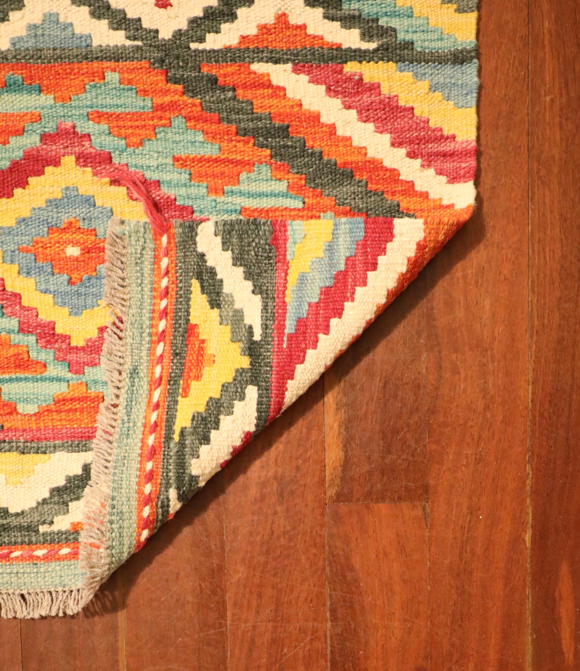 The Afghan Hand Woven Khyber Kilim - 65 X 90. Crafted using traditional vegetable dyed wool, and featuring traditional geometric designs. Colours, reds, beiges, creams, light greens, light blues and yellows. Size 65 X 90. Fold.