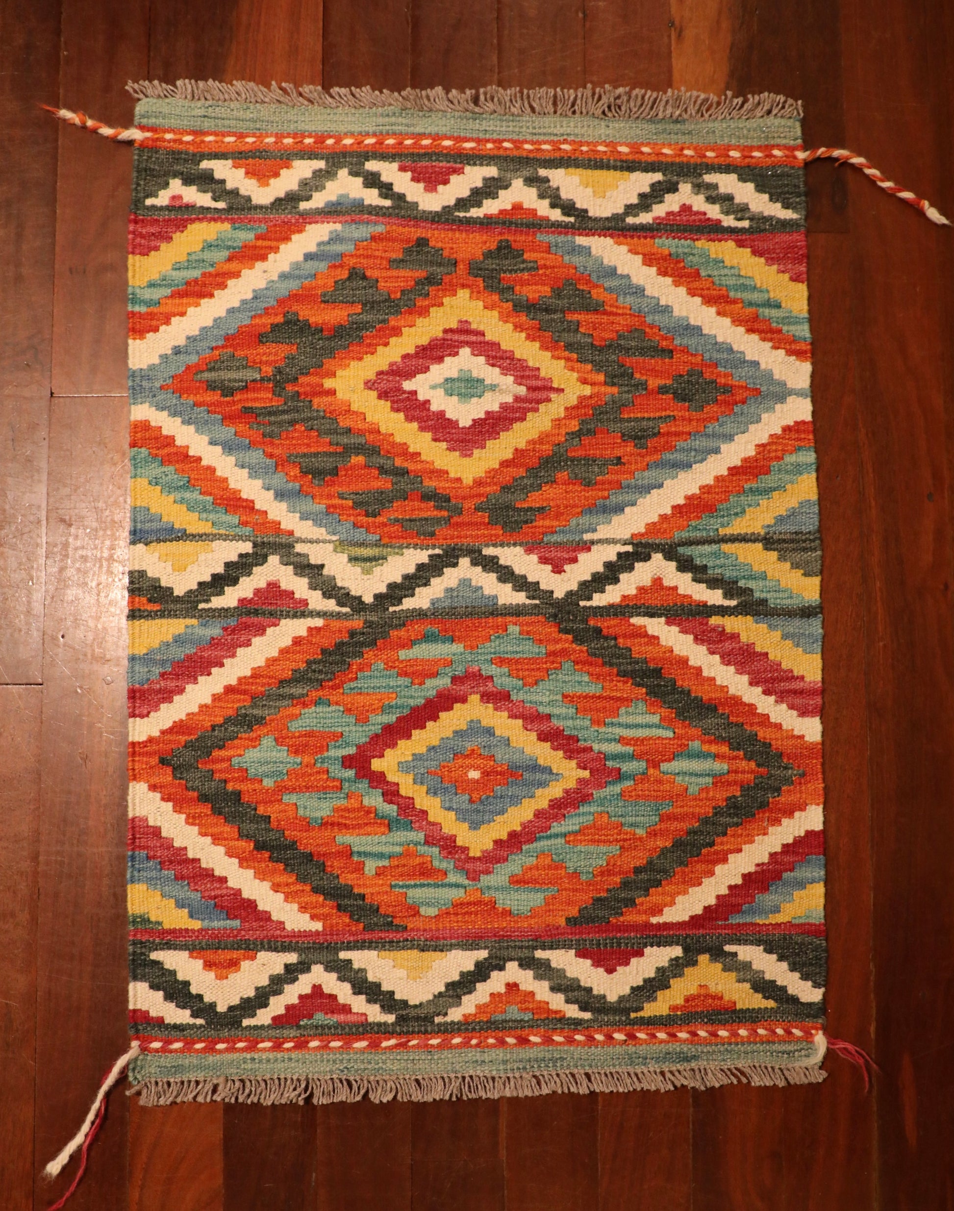 The Afghan Hand Woven Khyber Kilim - 65 X 90. Crafted using traditional vegetable dyed wool, and featuring traditional geometric designs. Colours, reds, beiges, creams, light greens, light blues and yellows. Size 65 X 90. Top.