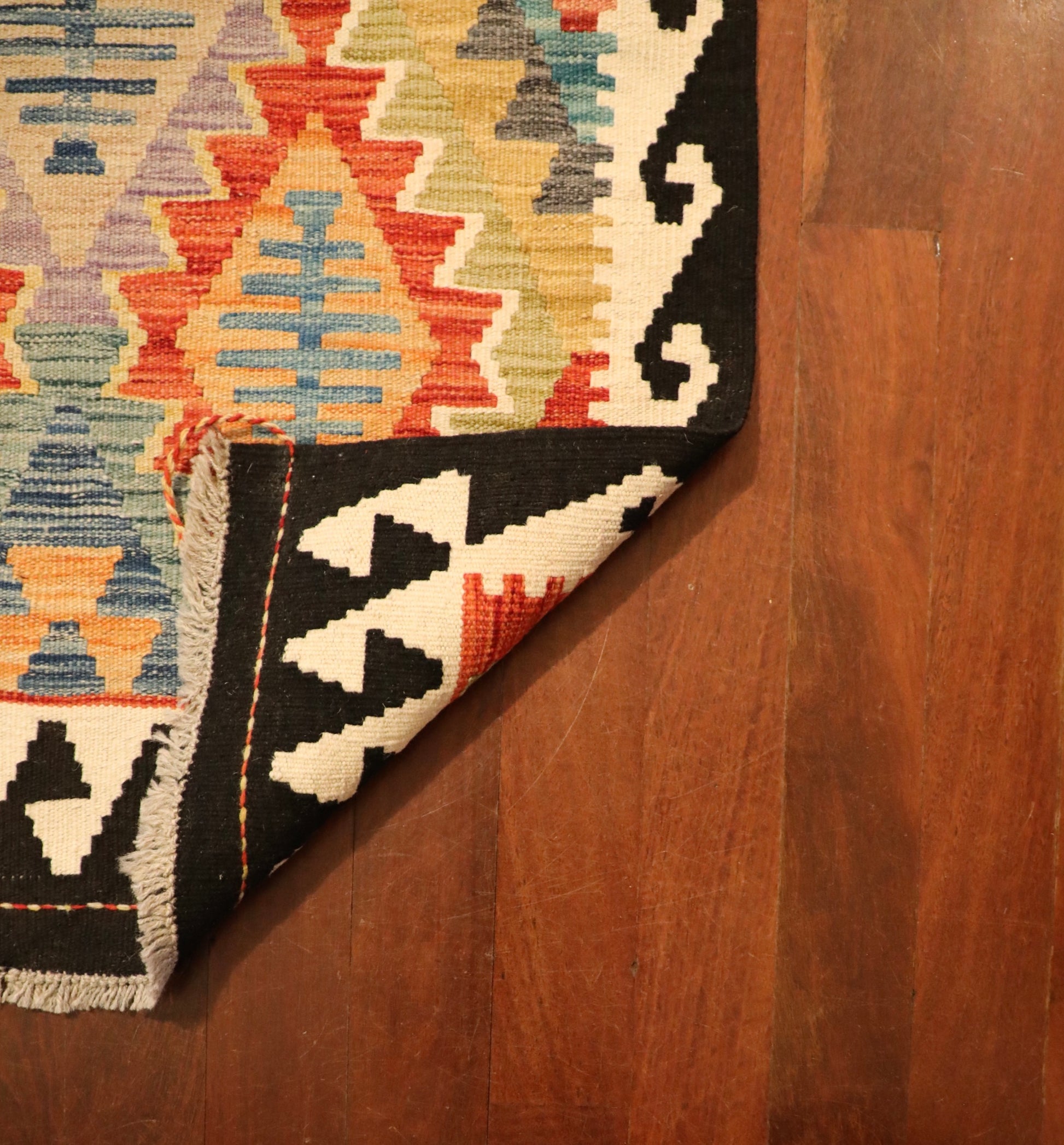 The Afghan Hand Woven Khyber Kilim Runner - 79 X 293.  Crafted using traditional vegetable dyed wool, and featuring traditional geometric designs. Colours, dark blue, creams, beiges, oranges, light greens and more. Measures 79 wide X 293 long. Fold.