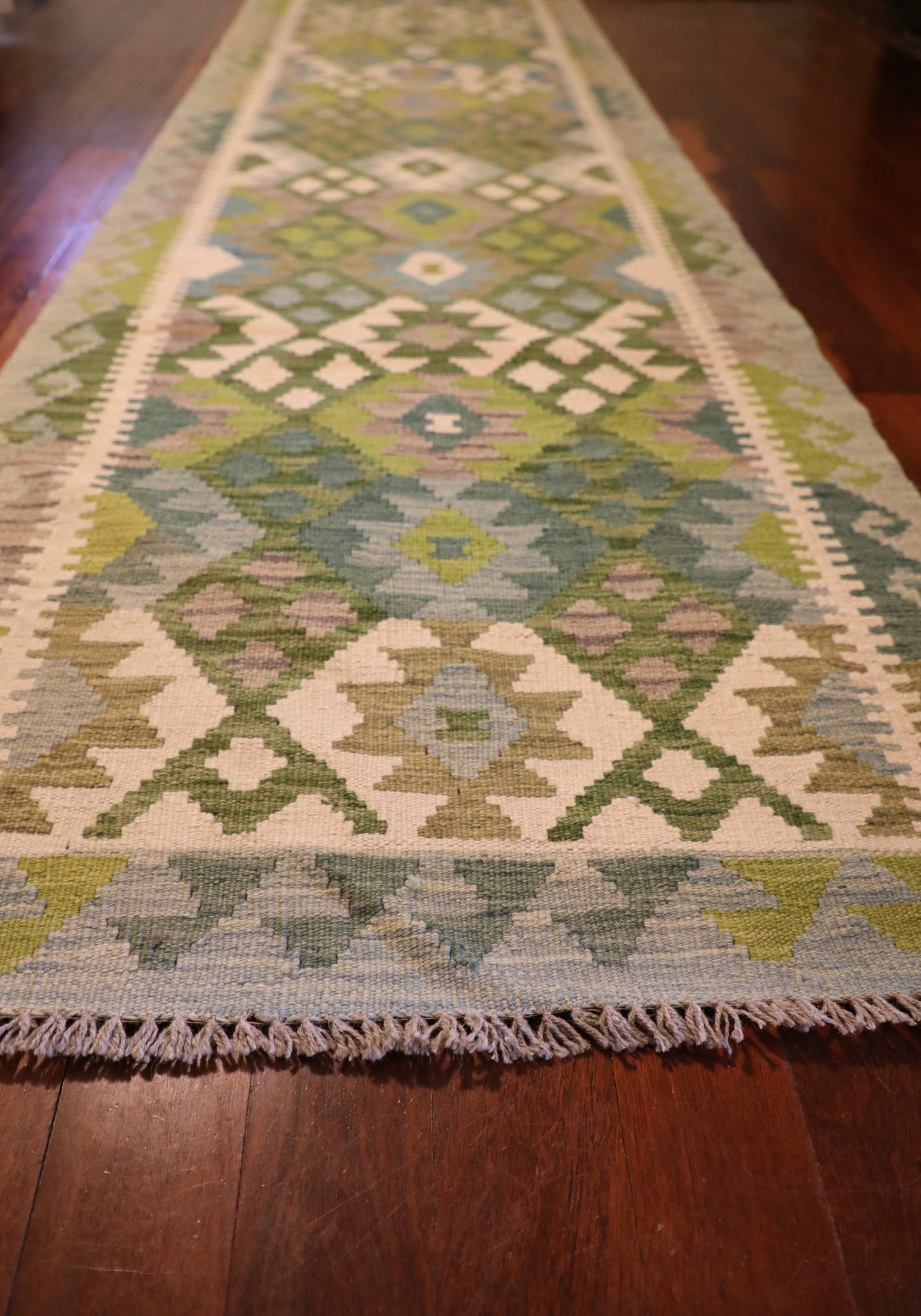 Khyber Kilim Rug Runner 82 X 312.  Hand woven wool with vegetable dyes.  Colours greens, greys and creams. Measures 82 wide x 312 length. Angle.