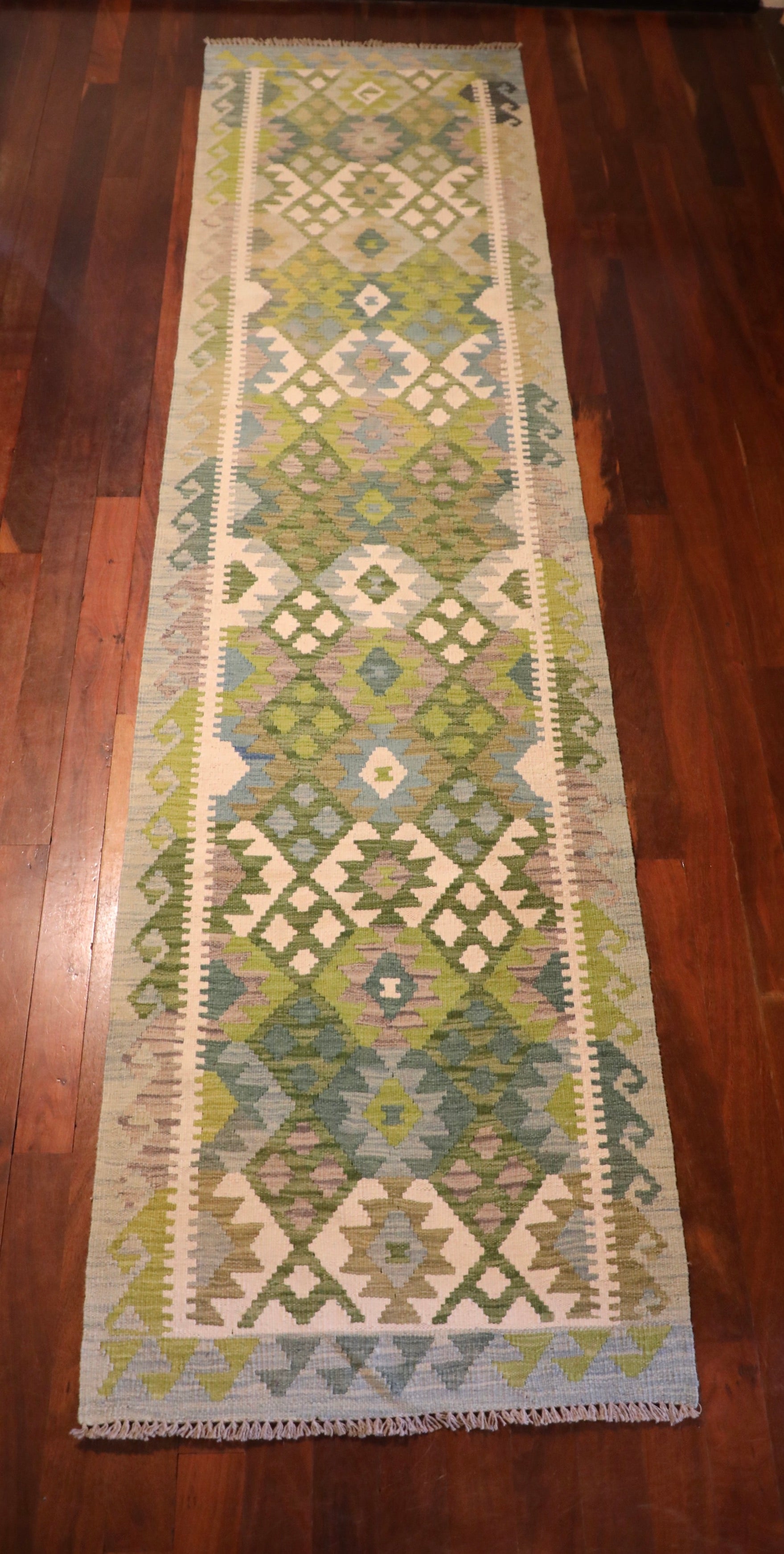 Khyber Kilim Rug Runner 82 X 312.  Hand woven wool with vegetable dyes.  Colours greens, greys and creams. Measures 82 wide x 312 length. Top.