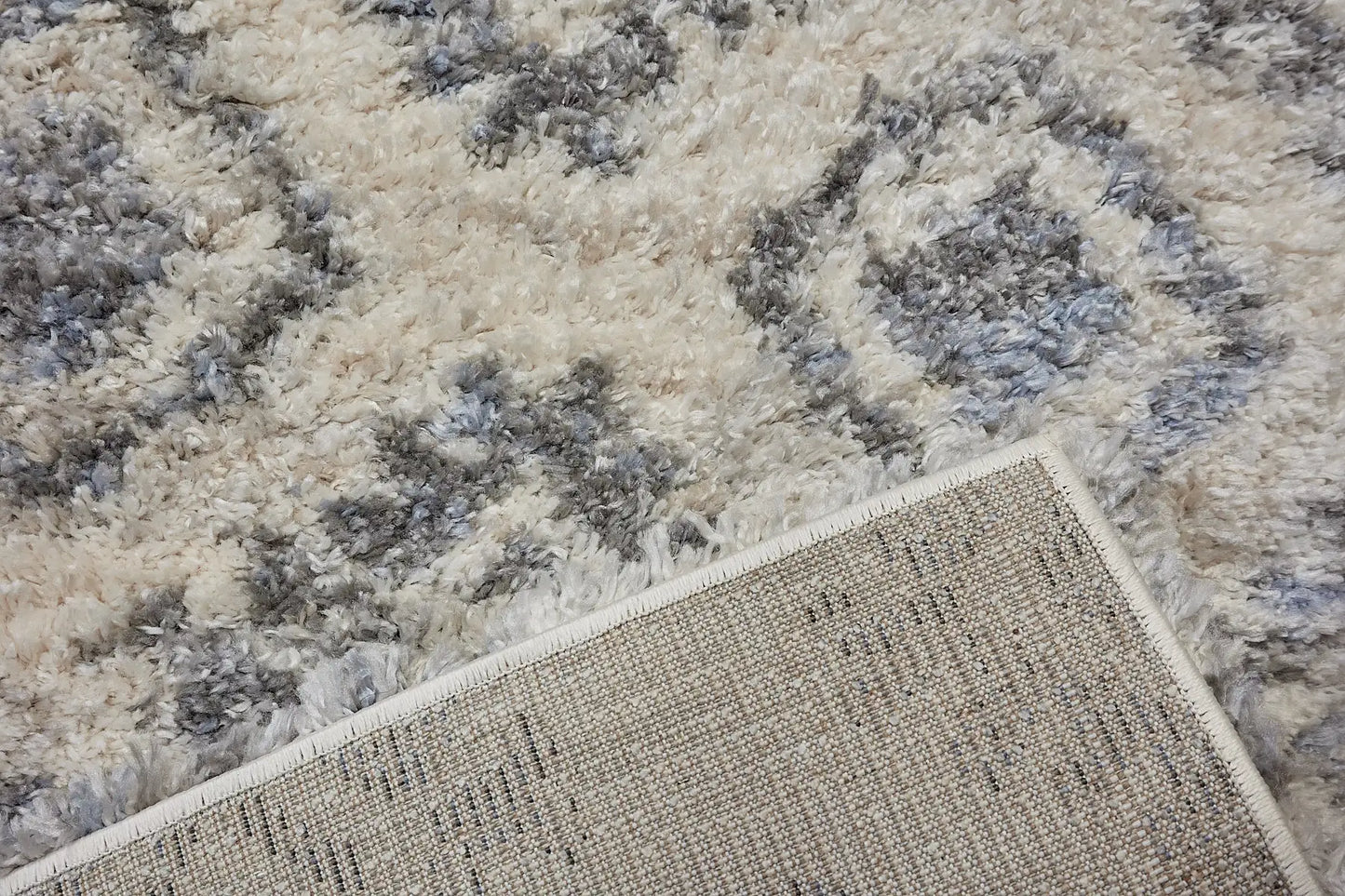 Konya Cream is a Moroccan/Boho inspiration rug.  Machine made of Polyester, this shaggy style rugs brings added soften textures.  Colours white and blue. Sizes 160 X 230, 200 X 290, 240 X 340 and 300 X 400. Fold.