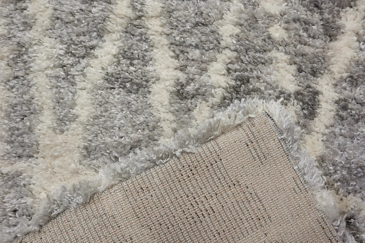 Konya Grey is a Moroccan/Boho inspiration rug.  Machine made of Polyester, this shaggy style rugs brings added soften textures.  Colours Grey, White and Light Grey. Sizes 160 X 230, 200 X 290, 240 X 340 and 300 X 400. Fold.