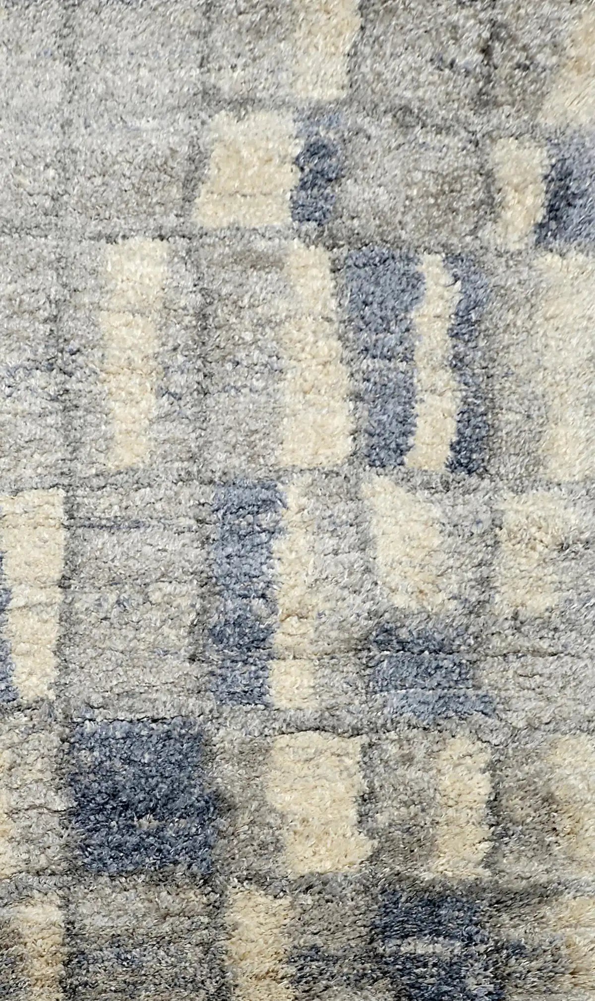 Konya Recta is a Moroccan/Boho inspiration rug.  Machine made of Polyester, this shaggy style rugs brings added soften textures.  Colours Grey, White, Blue and Light Grey. Sizes 160 X 230, 200 X 290, 240 X 340 and 300 X 400. Full.