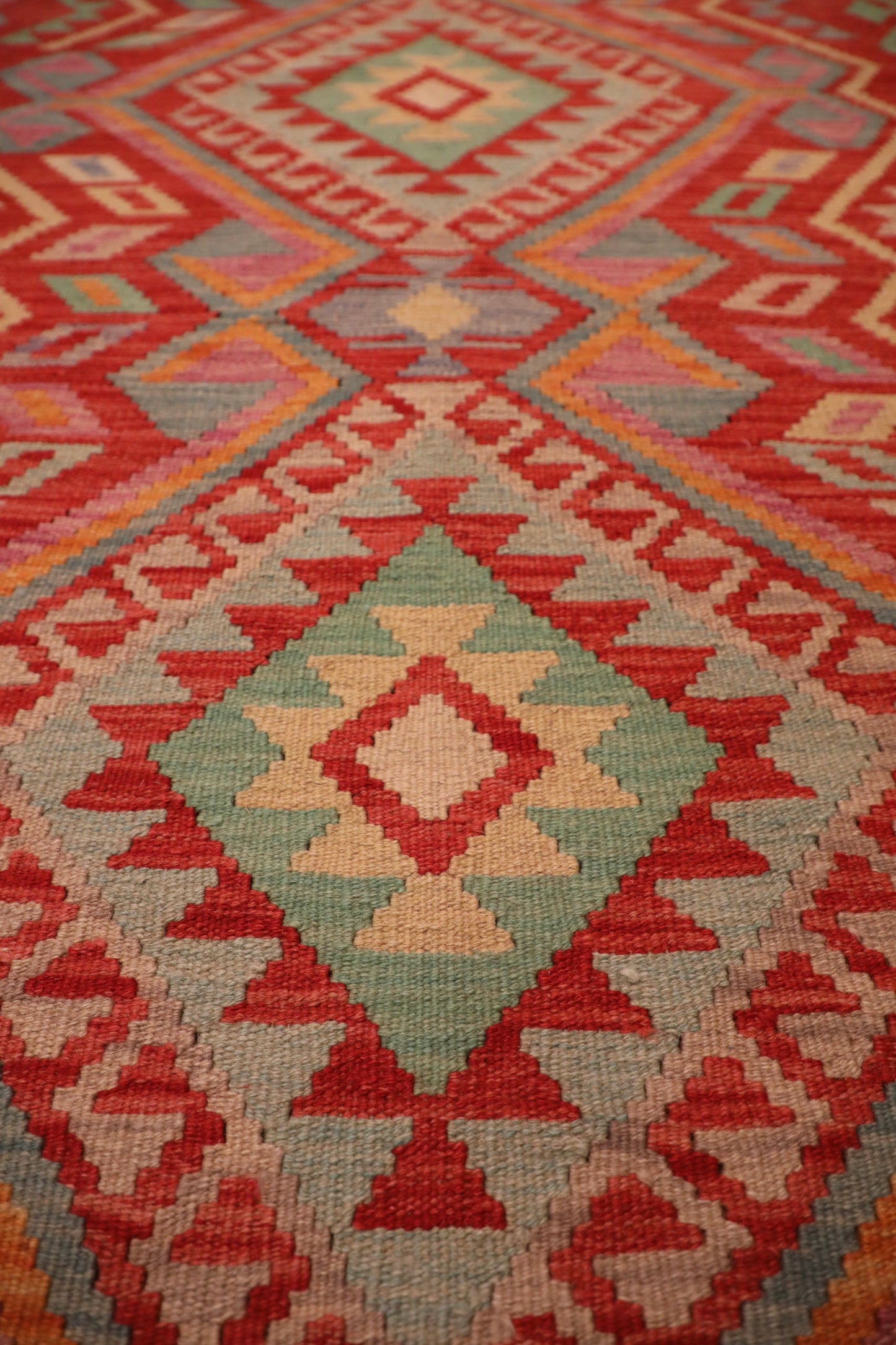 The Afghan Hand Woven Khyber Kilim - 124 X 176. Crafted using traditional vegetable dyed wool, and featuring traditional geometric designs. Colours, Oranges, beiges, creams, lavender. Size 124 X 176. Close.
