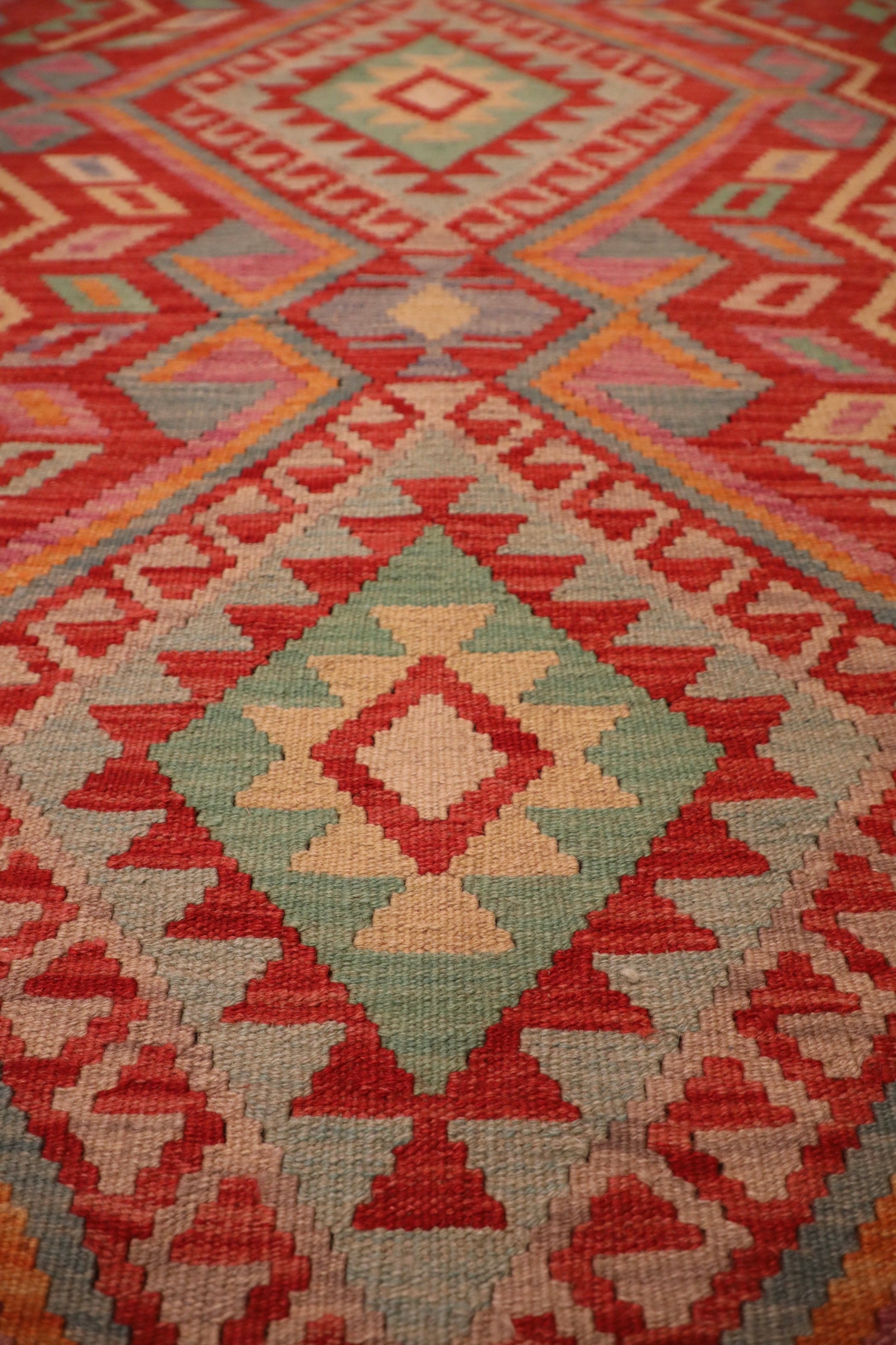 The Afghan Hand Woven Khyber Kilim - 124 X 176. Crafted using traditional vegetable dyed wool, and featuring traditional geometric designs. Colours, Oranges, beiges, creams, lavender. Size 124 X 176. Close.
