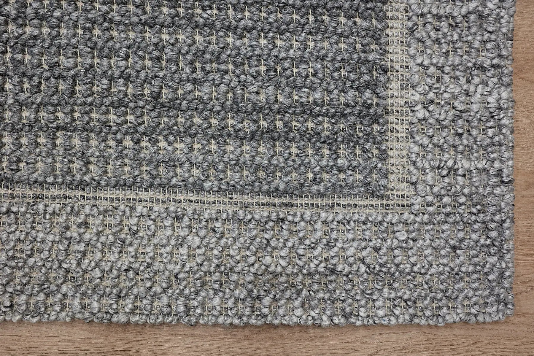 Liberty Ash is an eco-luxury rug crafted with hand woven recycled PET (plastic bottles) yarn. Boasting a super soft textured loop pile and pile height of 16-18mm. Colour Grey and Light Grey. Sizes 160 X 230, 200 X 290, 240 X 340 and 290 X 390. Corner.