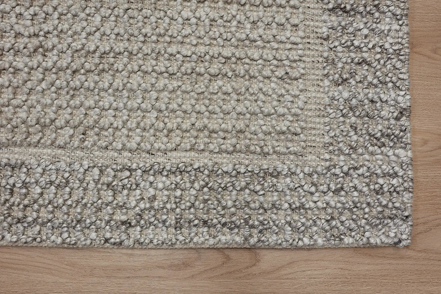 Liberty Limestone is an eco-luxury rug crafted with hand woven recycled PET (plastic bottles) yarn. Boasting a super soft textured loop pile and pile height of 16-18mm. Colour Light Grey and Beige Grey. Sizes 160 X 230, 200 X 290, 240 X 340 and 290 X 390. Corner.