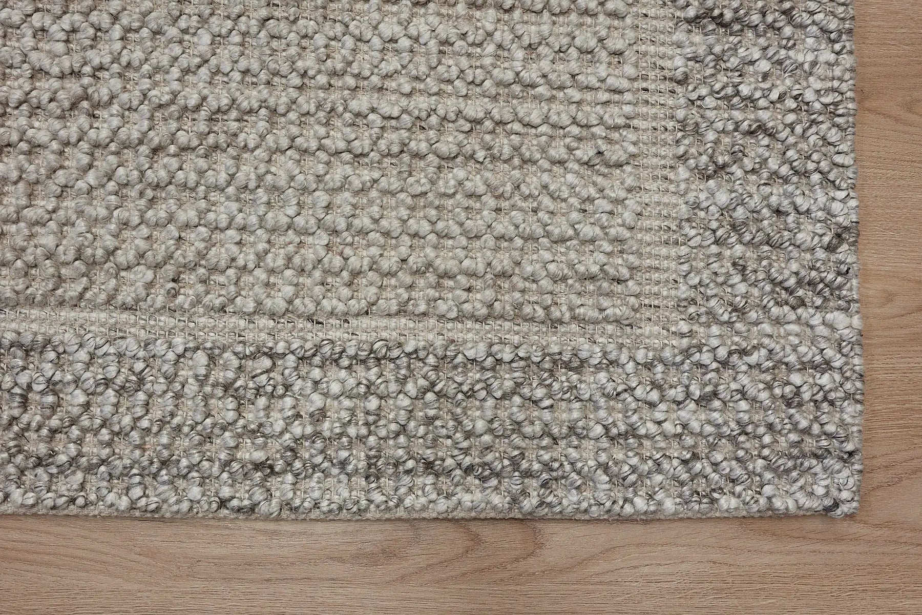 Liberty Limestone is an eco-luxury rug crafted with hand woven recycled PET (plastic bottles) yarn. Boasting a super soft textured loop pile and pile height of 16-18mm. Colour Light Grey and Beige Grey. Sizes 160 X 230, 200 X 290, 240 X 340 and 290 X 390. Corner.