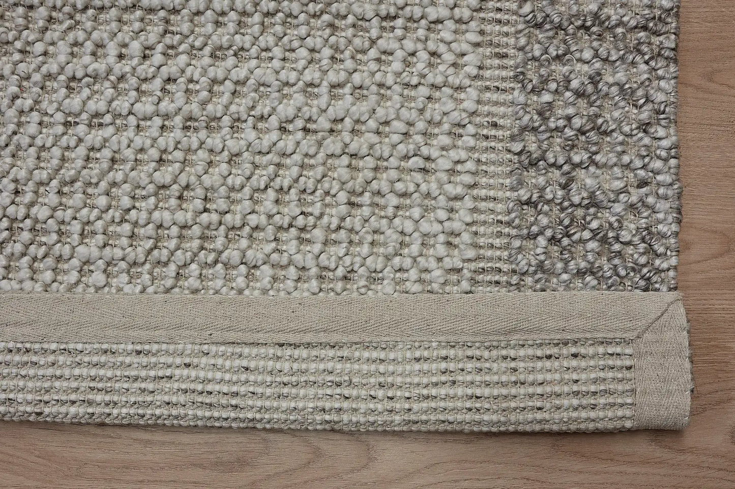 Liberty Limestone is an eco-luxury rug crafted with hand woven recycled PET (plastic bottles) yarn. Boasting a super soft textured loop pile and pile height of 16-18mm. Colour Light Grey and Beige Grey. Sizes 160 X 230, 200 X 290, 240 X 340 and 290 X 390. Fold.