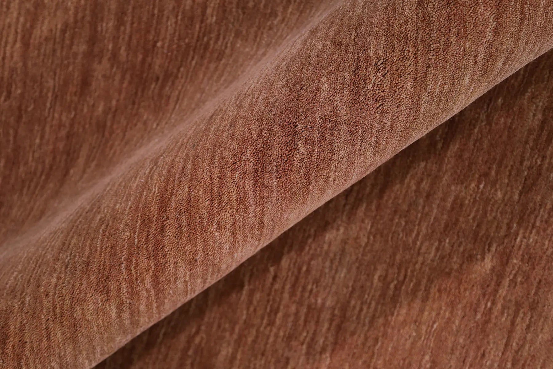 Lori Brick is a luxurious hand loomed floor rug made of 100% wool. The wool material creates a soft texture and a smooth pile height of 16-18mm. Colour orangish/redish terracotta with cream tassels. Sizes 160 X 230, 200 X 290, 240 X 340 and 300 X 400. Roll.