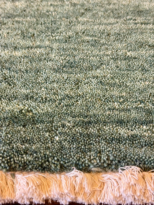 Lori Green is a luxurious hand loomed floor rug made of 100% wool. The wool material creates a soft texture and a smooth pile height of 16-18mm. Colour forrest green with cream tassels. Sizes 160 X 230, 200 X 290, 240 X 340 and 300 X 400. Close Edge.