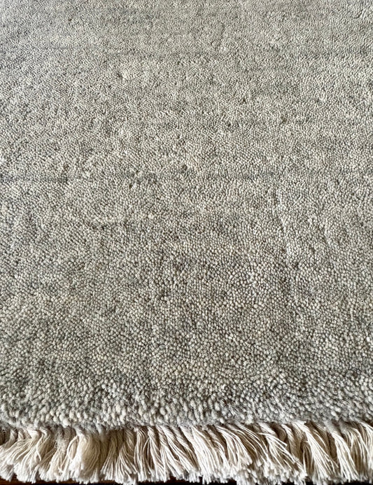 Lori Light Grey is a luxurious hand loomed floor rug made of 100% wool. The wool material creates a soft texture and a smooth pile height of 16-18mm. Colour Light Grey with cream tassels. Sizes 160 X 230, 200 X 290, 240 X 340 and 300 X 400. Close edge.