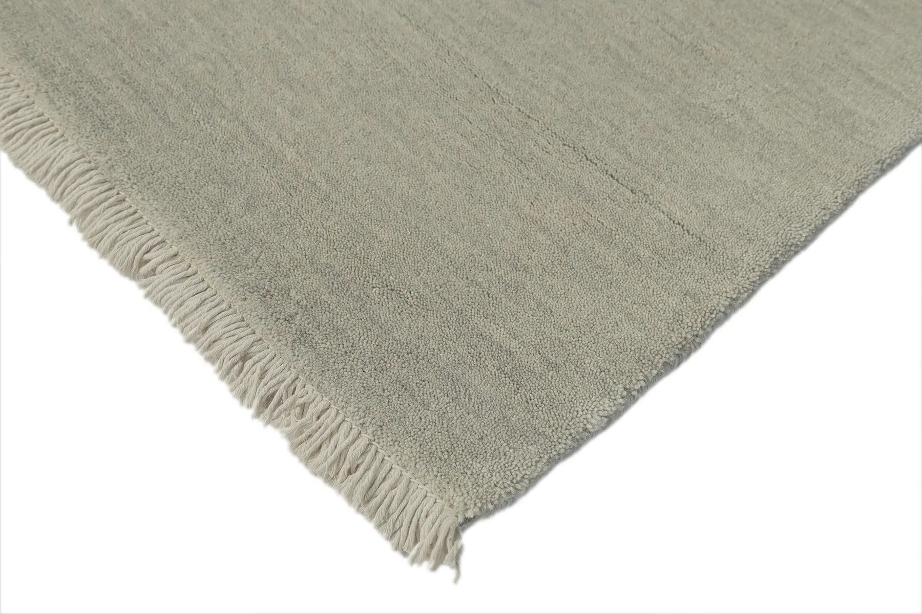 Lori Light Grey is a luxurious hand loomed floor rug made of 100% wool. The wool material creates a soft texture and a smooth pile height of 16-18mm. Colour Light Grey with cream tassels. Sizes 160 X 230, 200 X 290, 240 X 340 and 300 X 400. Corner.