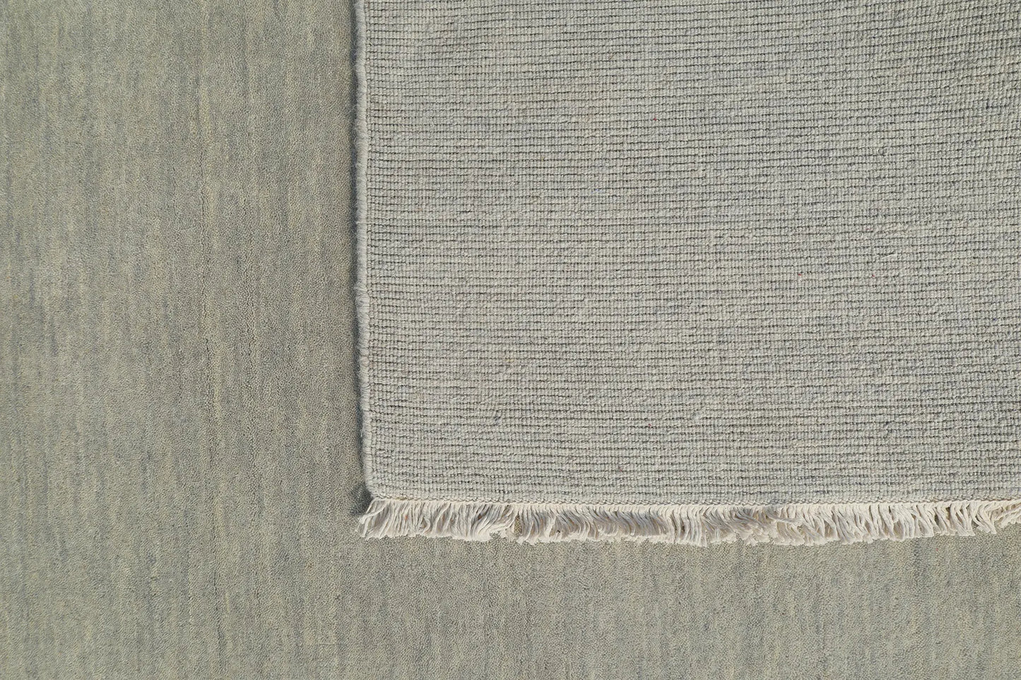 Lori Light Grey is a luxurious hand loomed floor rug made of 100% wool. The wool material creates a soft texture and a smooth pile height of 16-18mm. Colour Light Grey with cream tassels. Sizes 160 X 230, 200 X 290, 240 X 340 and 300 X 400. Fold.
