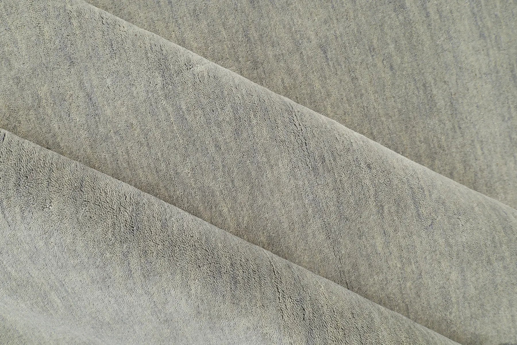 Lori Light Grey is a luxurious hand loomed floor rug made of 100% wool. The wool material creates a soft texture and a smooth pile height of 16-18mm. Colour Light Grey with cream tassels. Sizes 160 X 230, 200 X 290, 240 X 340 and 300 X 400. Roll.